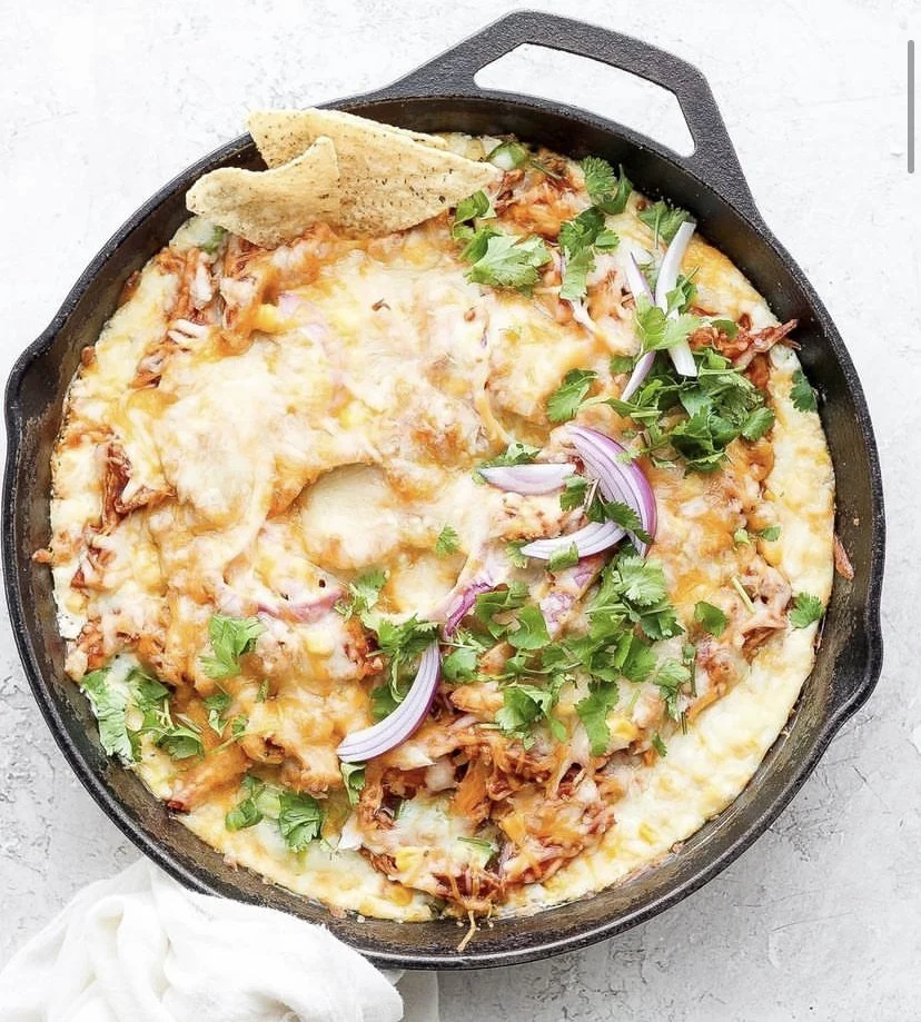 A BBQ Chicken Pizza Dip in a cast-iron skillet