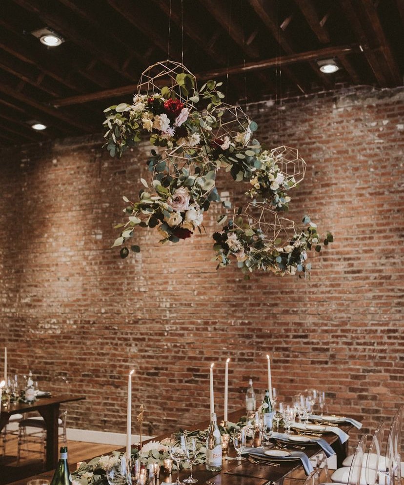 Slate Studio decorated for an event with greenery, florals, and candles.