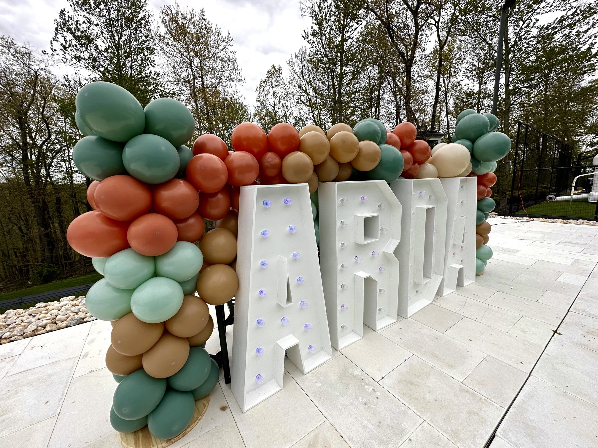 Balloon arch serves as a stunning wedding backdrop