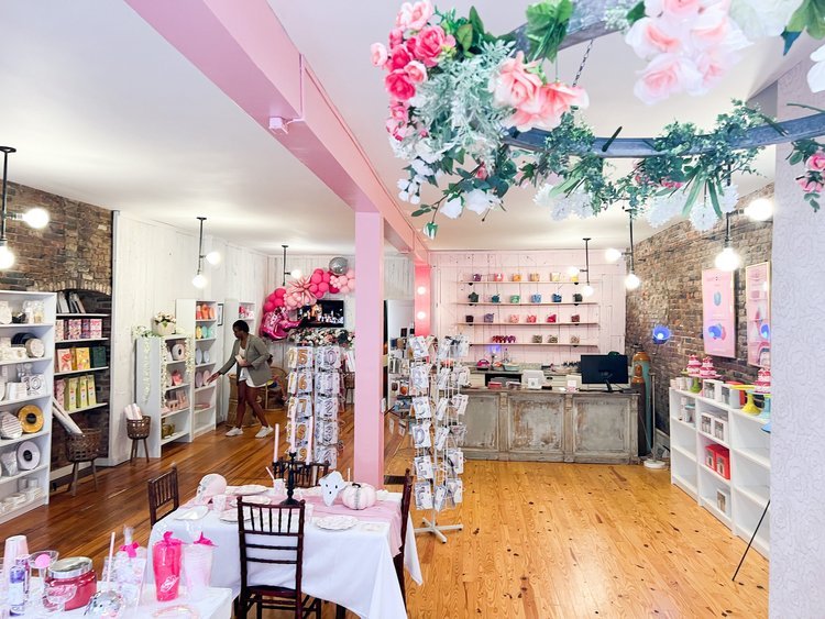 Party on Butler's event space with pink walls, exposed brick, and decorated with florals.