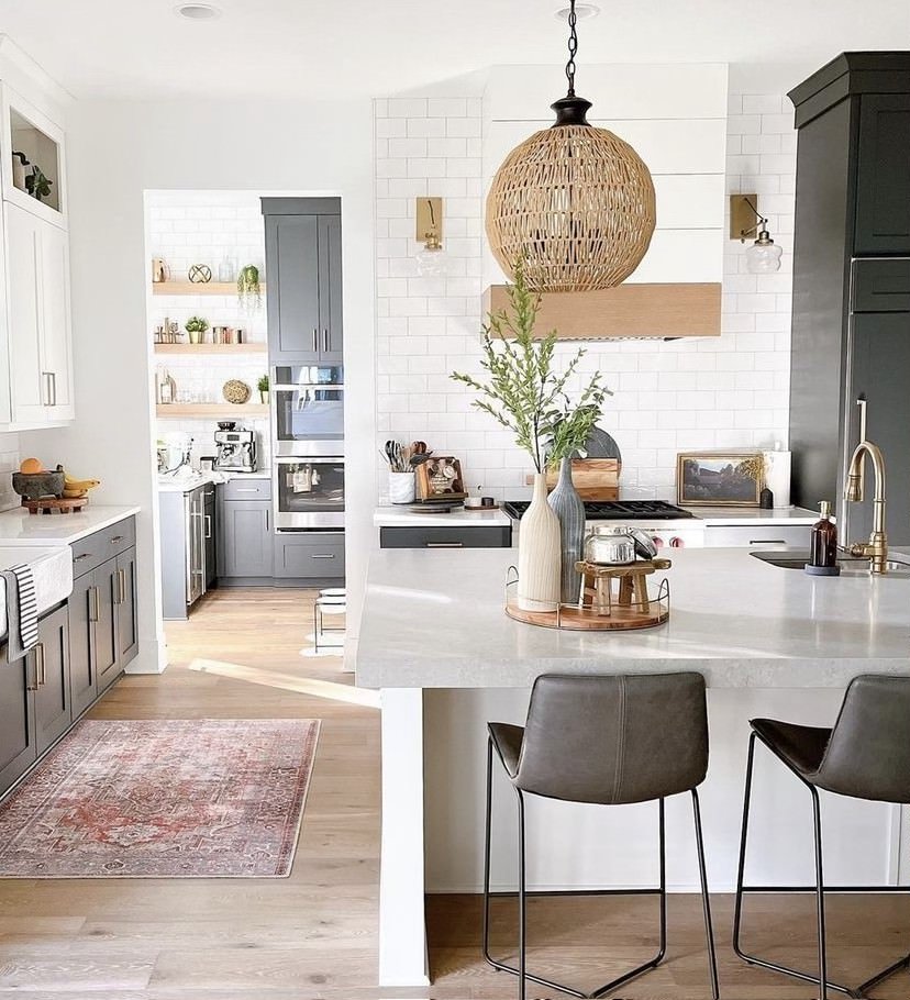 A white and grey kitchen with West Elm vases on the countertop