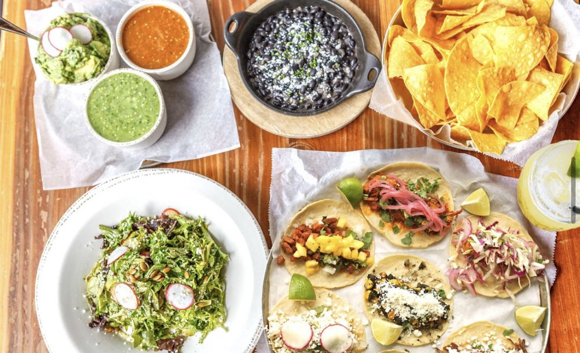 A spread of tacos, chips, salsa, beans, a salad, and a margarita from Bakersfield in Pittsburgh