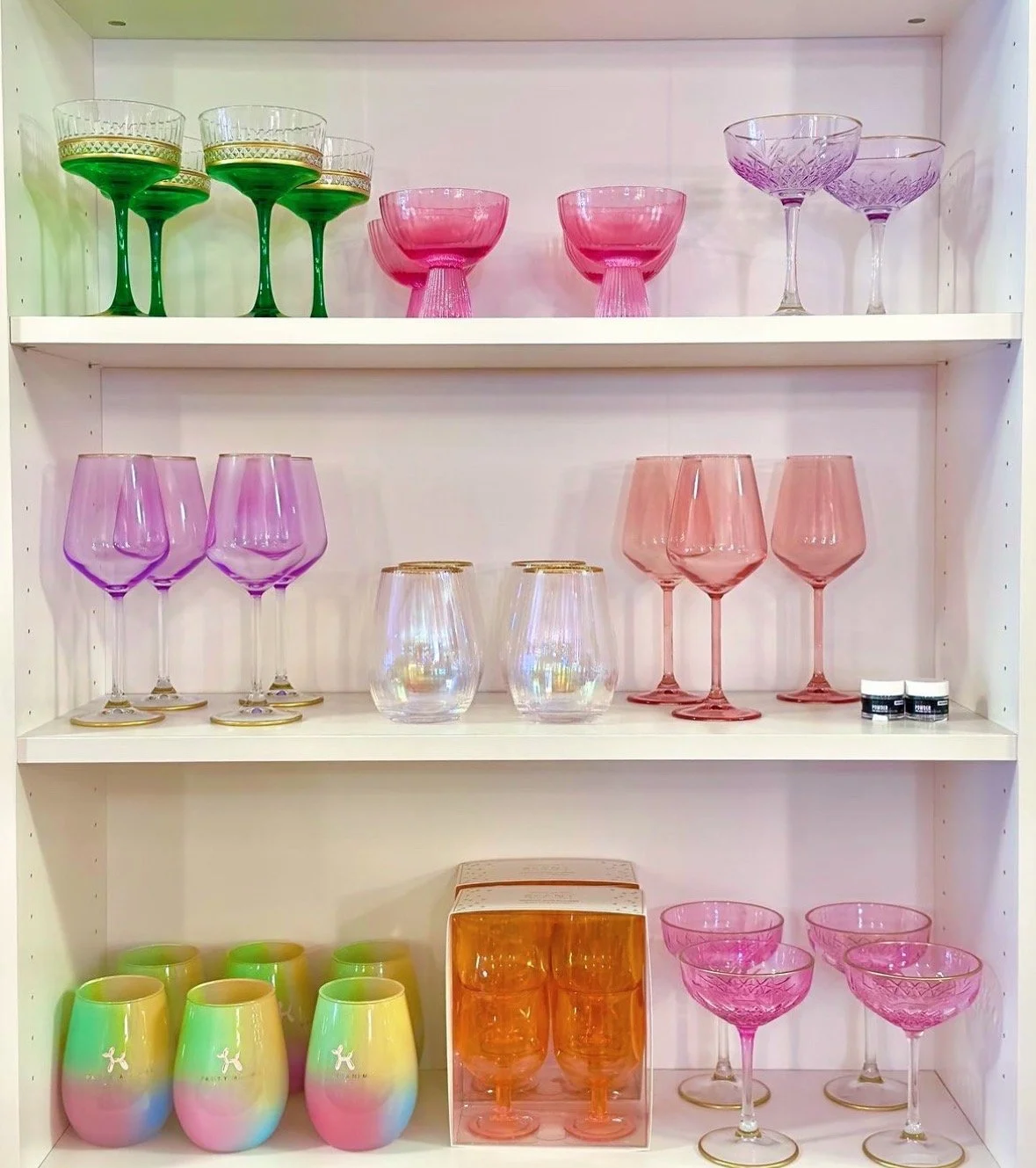 a wide variety of cocktail glasses and glassware and supplies and edible glitter in pastel colors like pink green purple gold etc perfect for mixology or mixologists