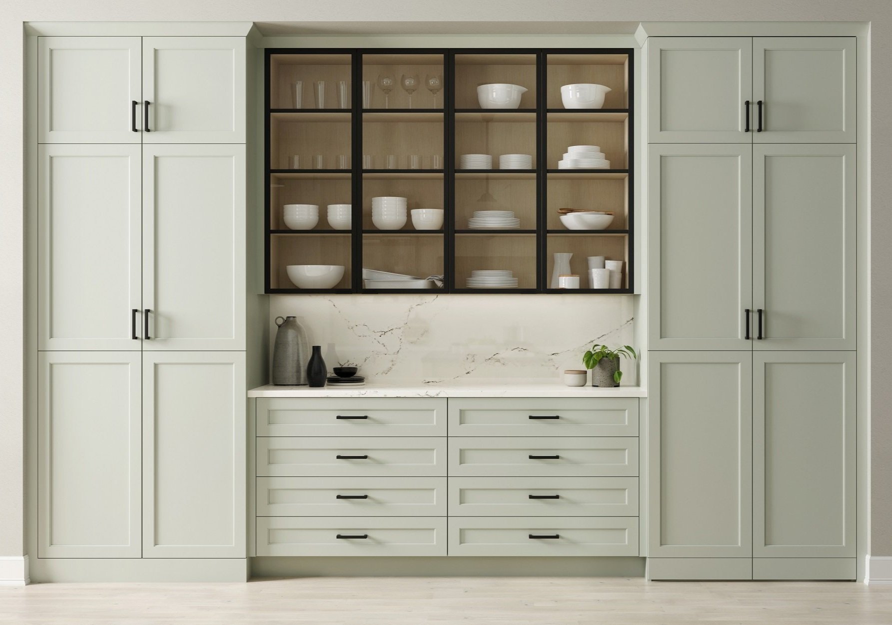 Kitchen cabinet with glass-fronted display of white bowls, plates, and glassware, flanked by tall pantry cabinets, and decorated with vases and a plant.
