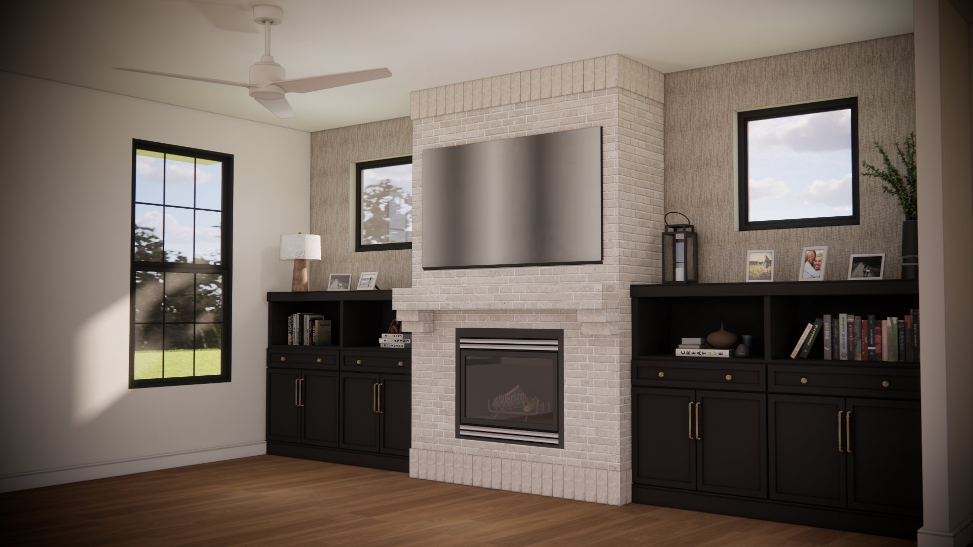 Living room with a brick fireplace, mounted TV, black cabinets, picture frames, and windows showing trees and sky.