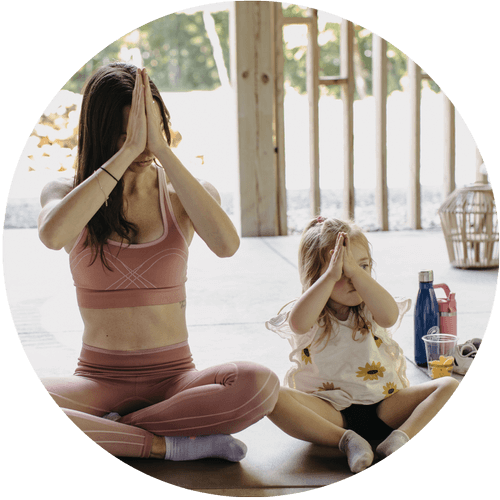 Woman and young girl doing yoga