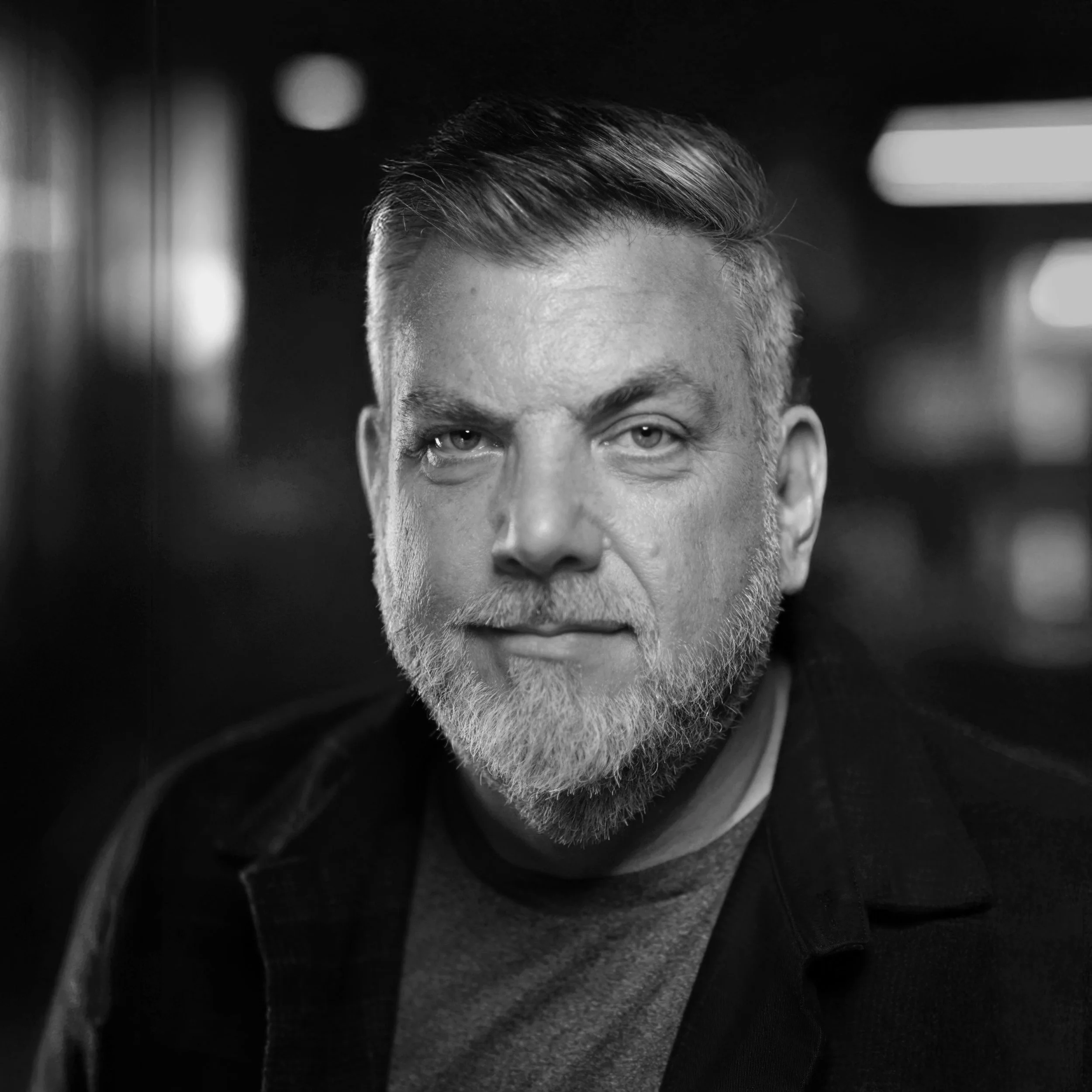 Medium angle, black and white portrait of Mike Best, a London based photographer, filmmaker and creative technologist.