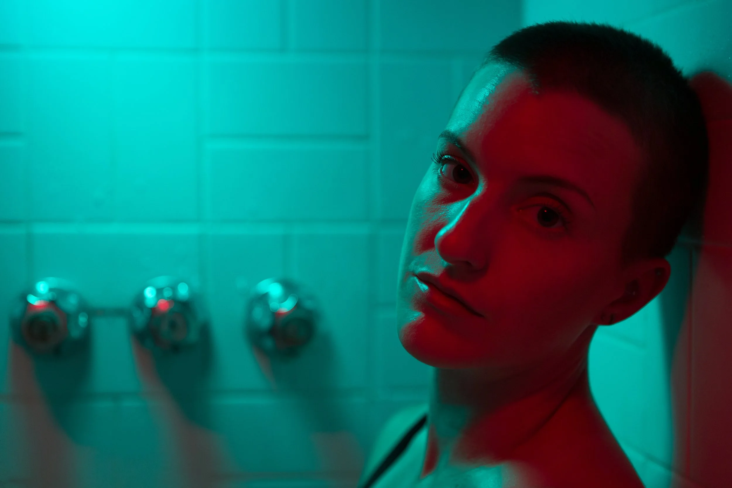 A close-up portrai photo of Christian Lopez sitting in the bathtub, looking out at the viewer