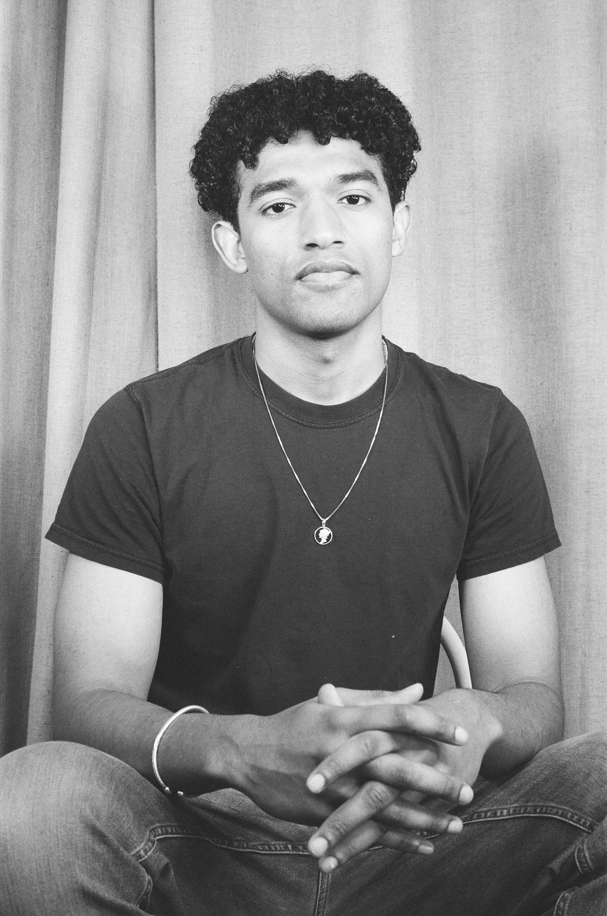 Ciaran Short, a young Black man, calmly looks at the viewer.