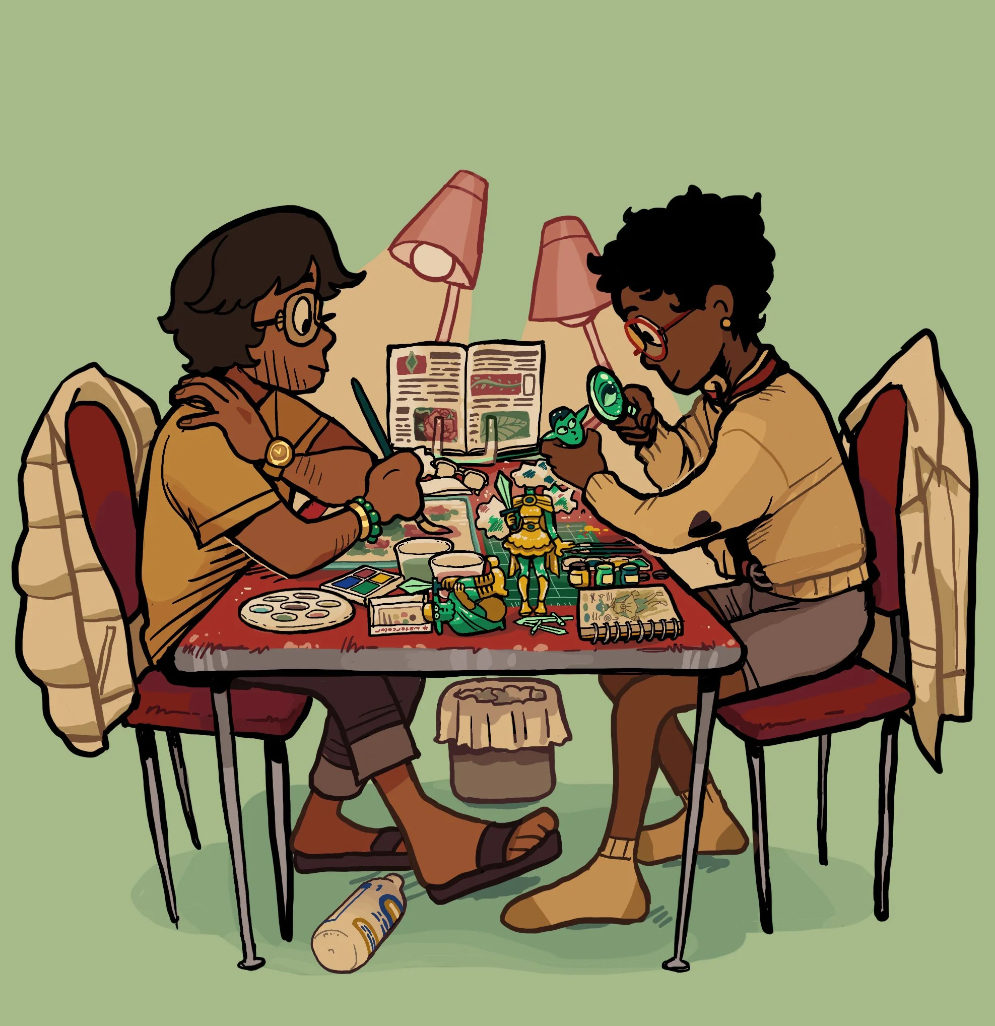 Two people with low vision sit at a table cluttered with art supplies, both wearing glasses.