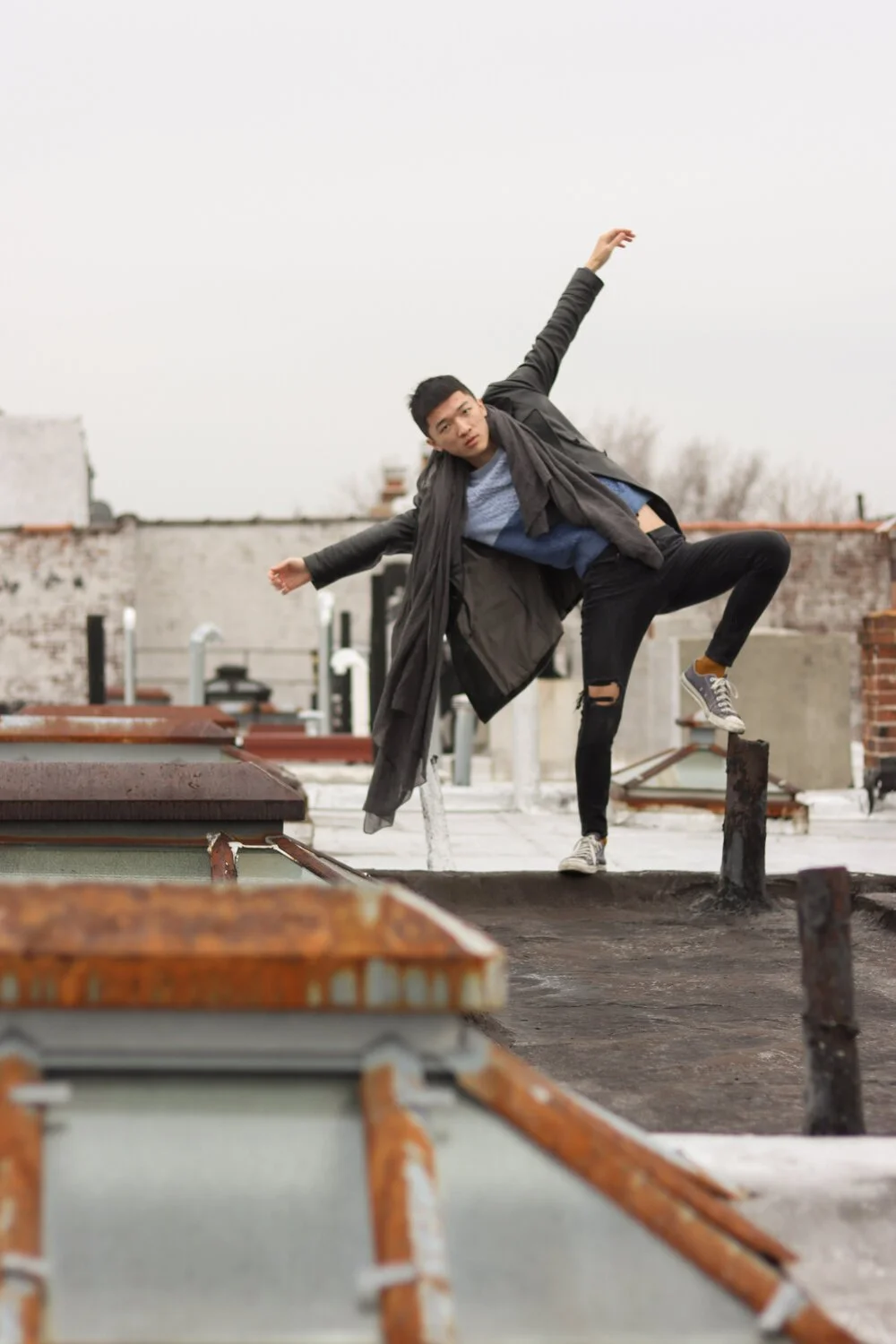 jiajia Wu standing on one leg and holding his arms out.