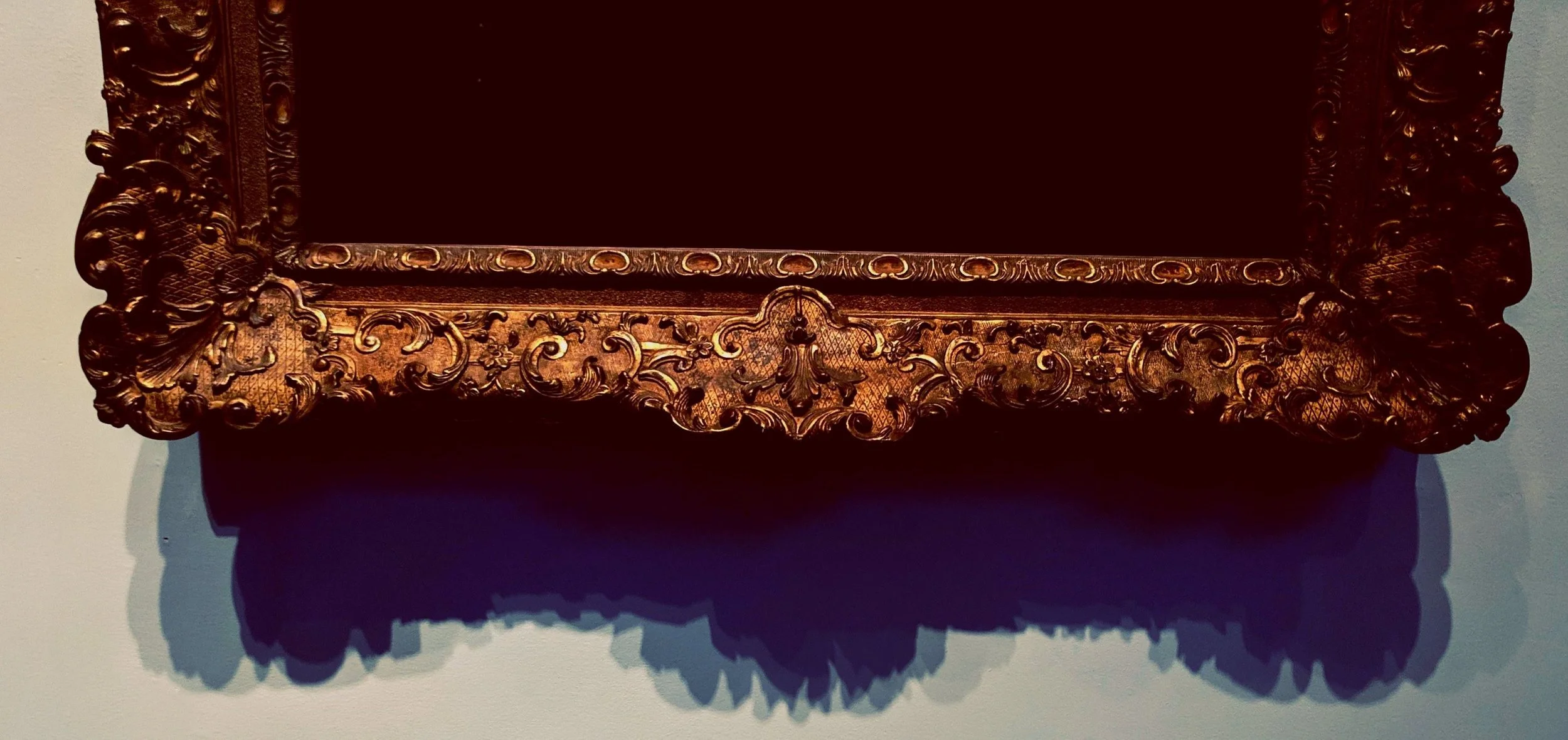 the cropped image of a gold ornate frame