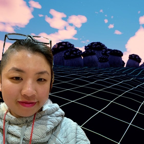 Image of the artist with a photo from "An Immersive Game of Life" installation behind her.