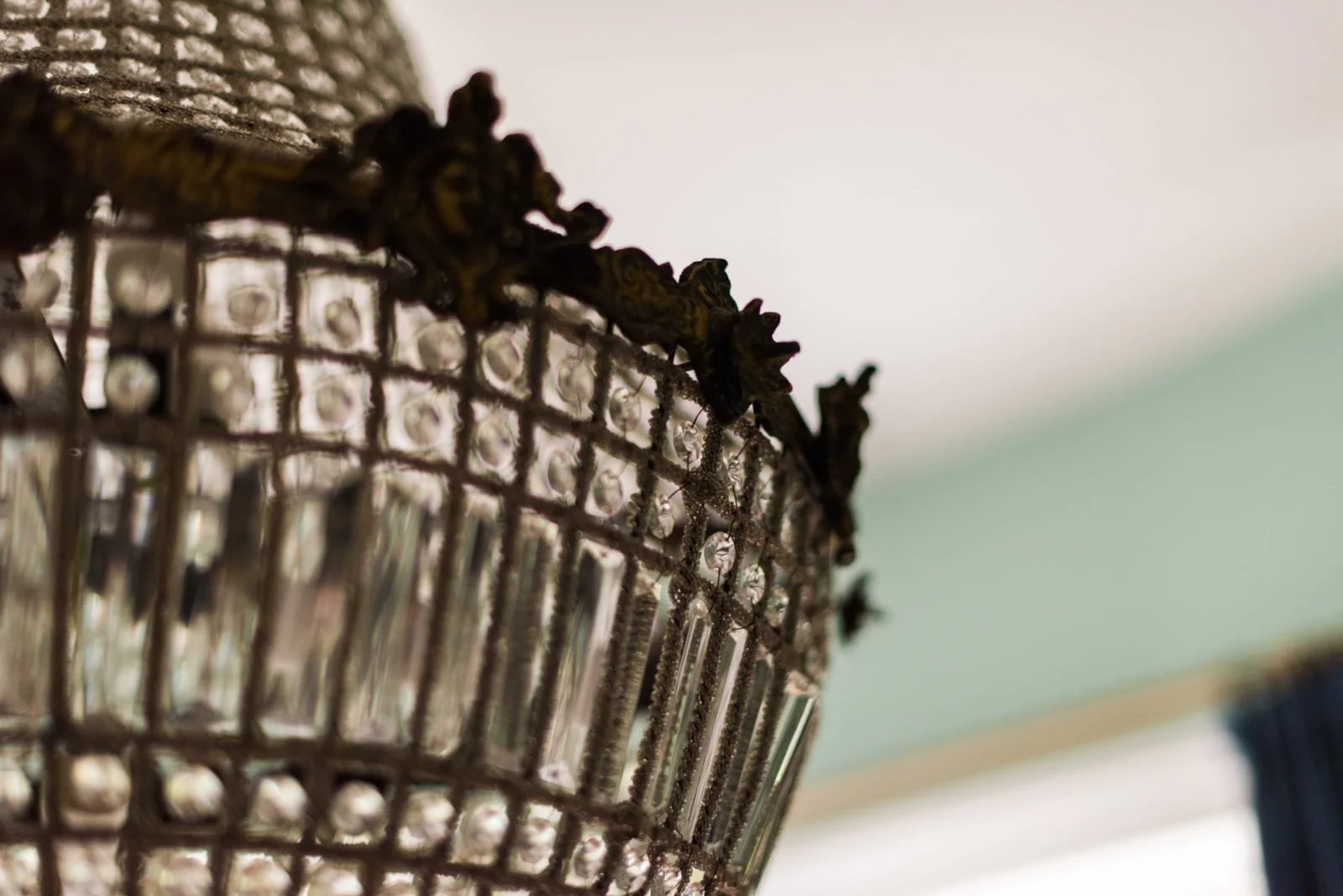 Close-up of a decorative crystal chandelier detail with intricate metalwork.