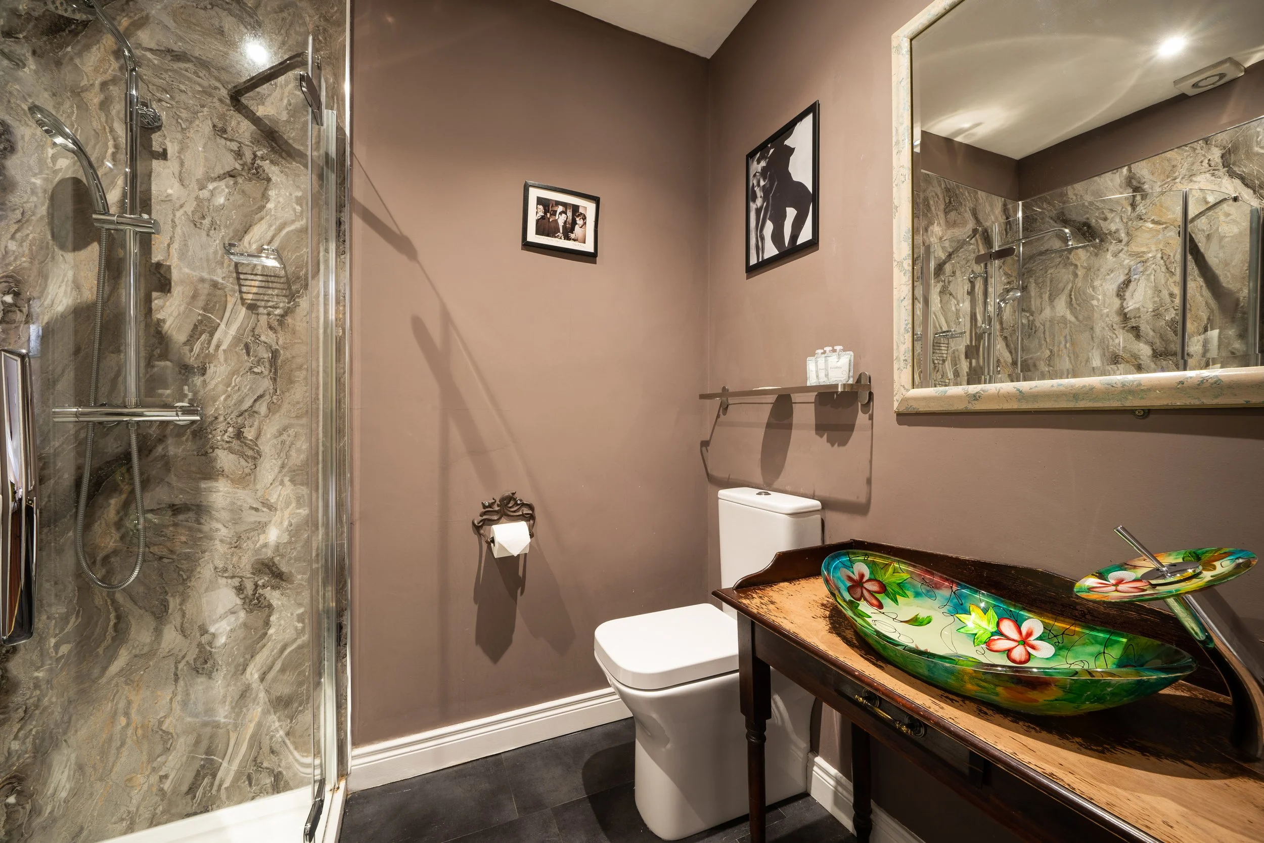 Stylish bathroom with floral sink and glass shower