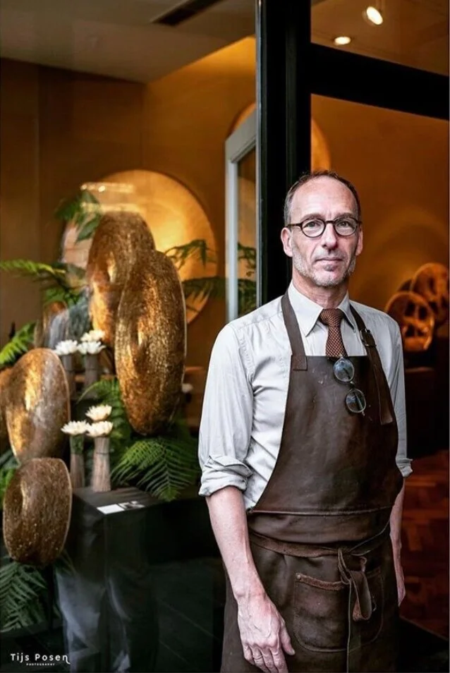 Michel Mullèr in his Antwerp gallery, surrounded by his artworks