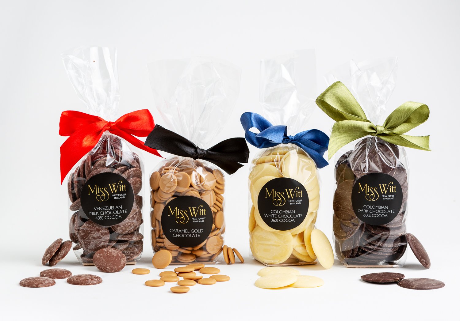 artisan dark chocolate the buttons are broken in pieces showing milk chocolate , white chocolate,