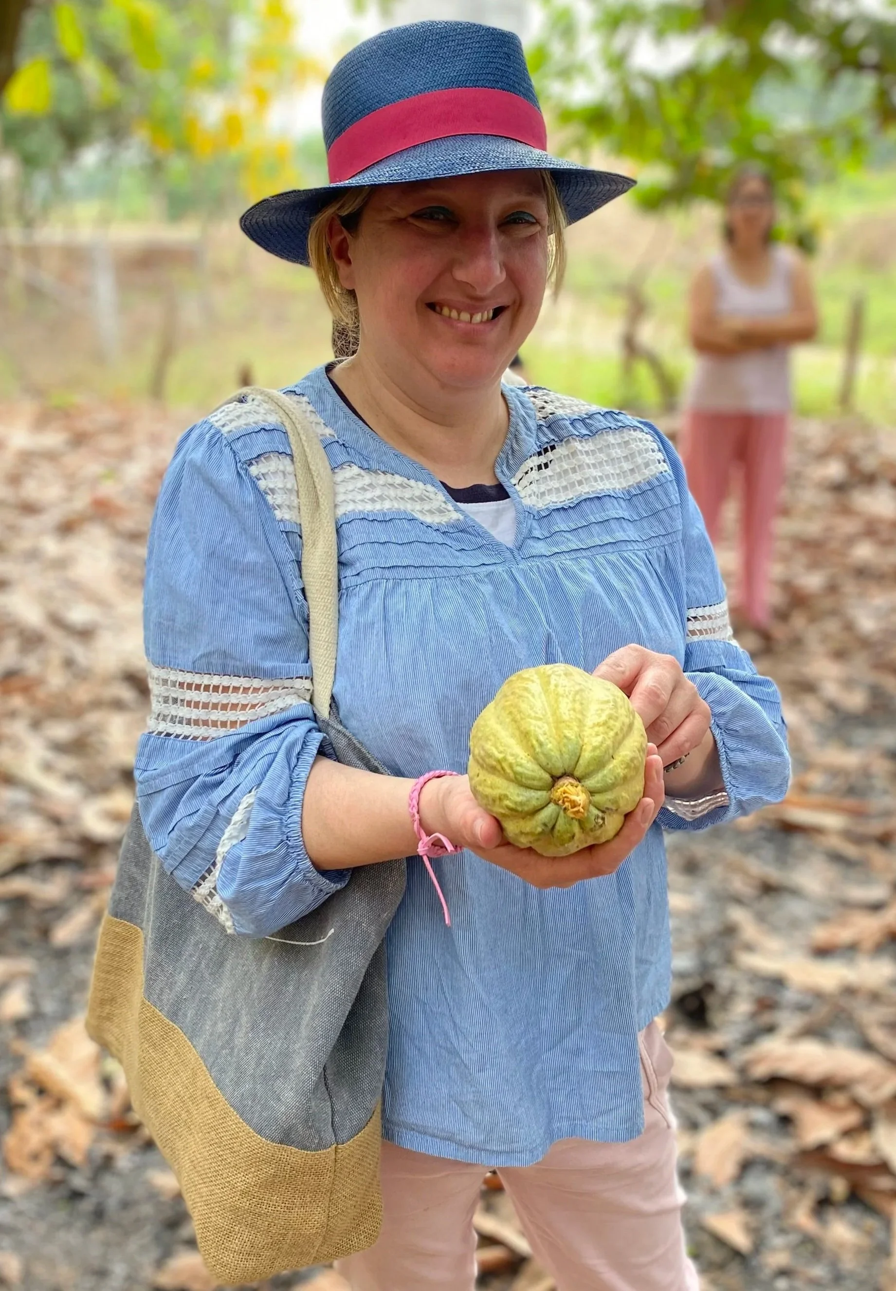 Chocolate teacher, Miss Witt with a cacao pod in Ecuador