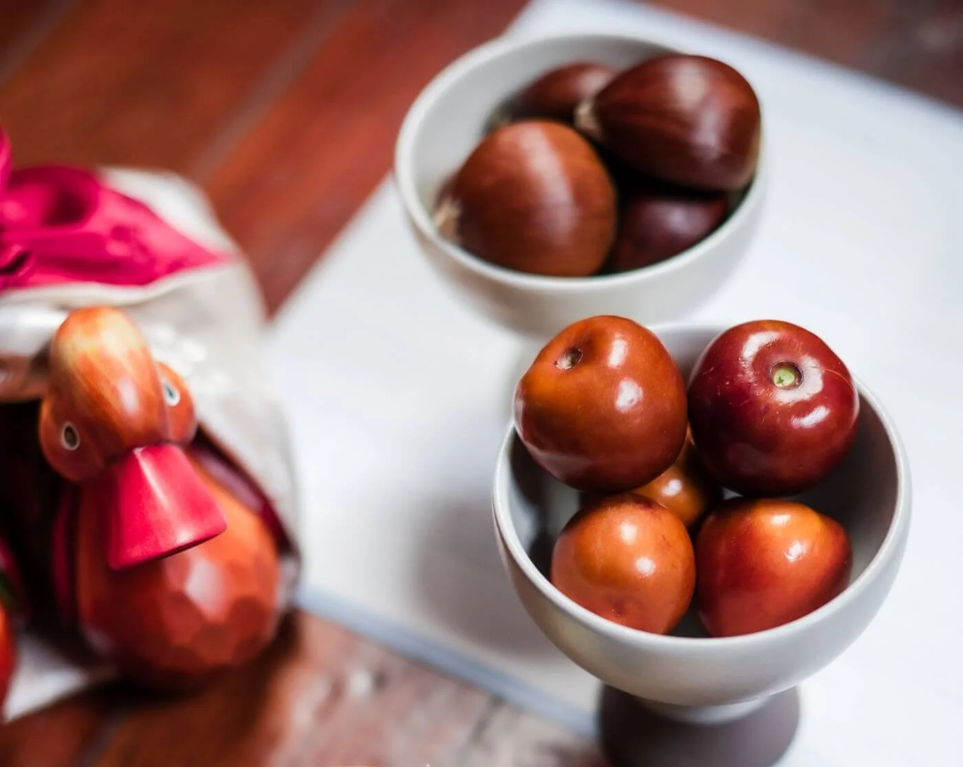 Jujubes and chestnuts in small ceramic bowls for a Korean wedding ritual in a modern queer ceremony.
