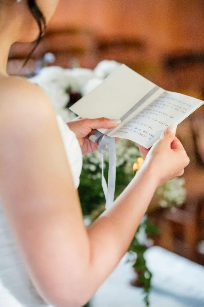 Bride reads their personal vows in Korean during a wedding ceremony.