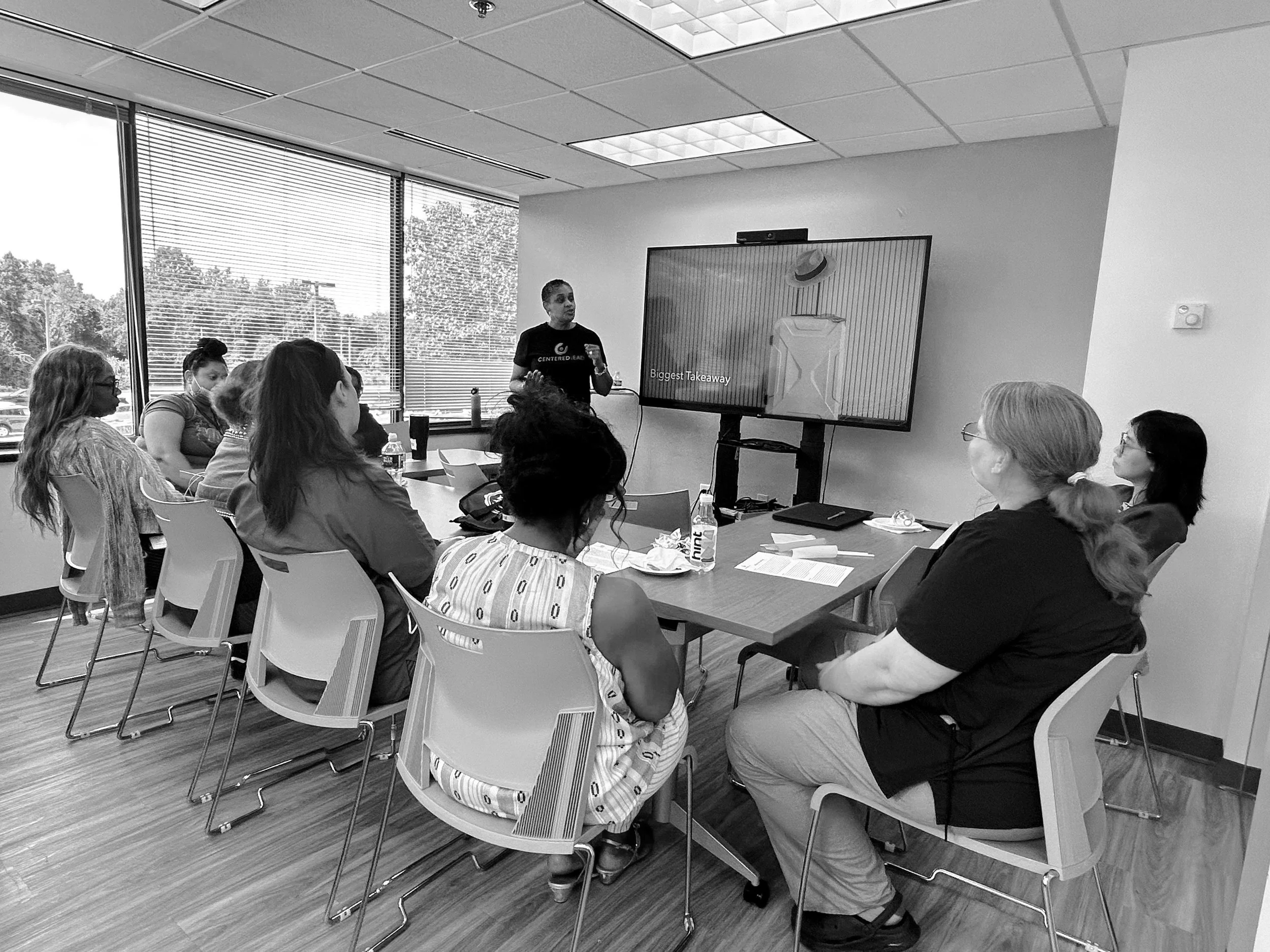 black woman facilitator coaching a group of attendees