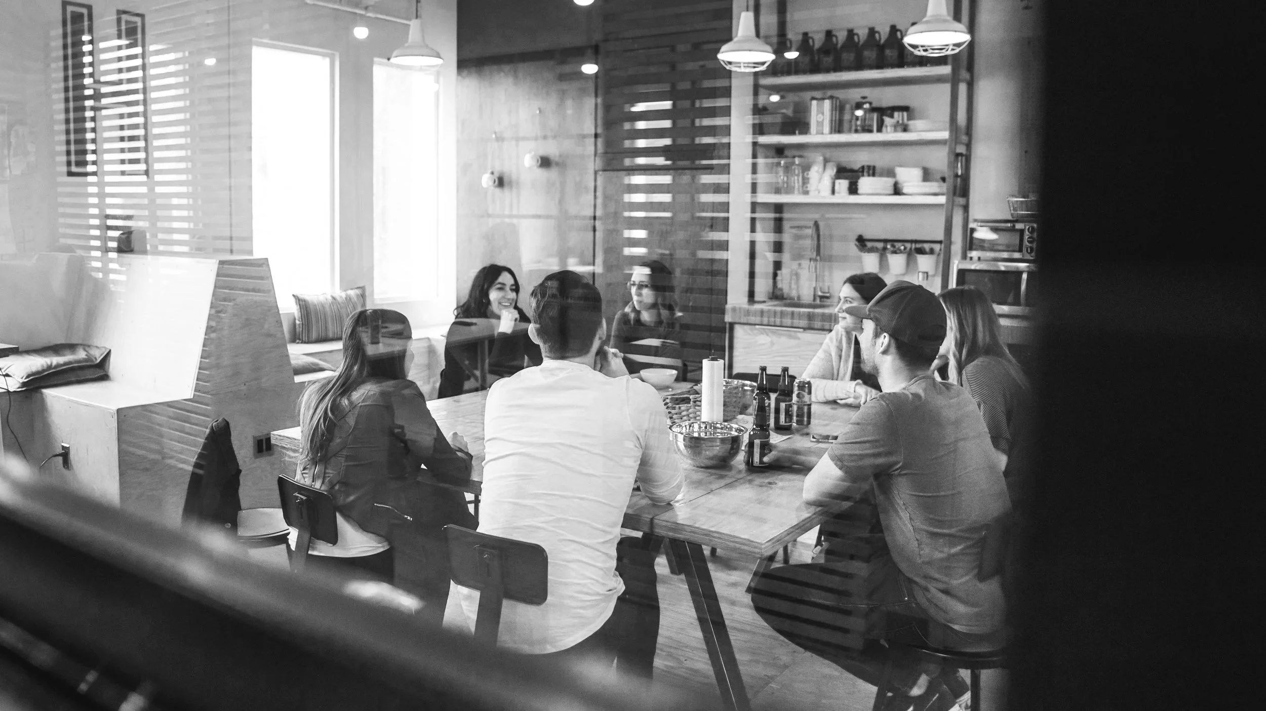 a group of seven people having a work meeting.