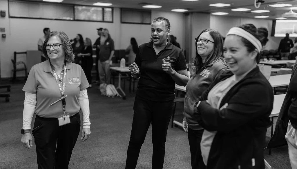 a facilitator with three women in a workshop