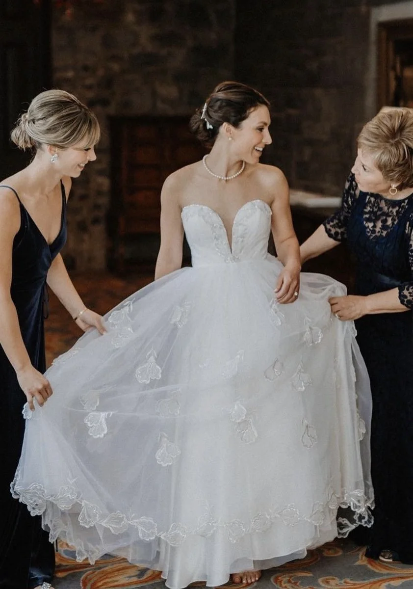 Bride with her mother and sister, wearing her Mother's dress that has been reimagined and custom made by Maybelle.