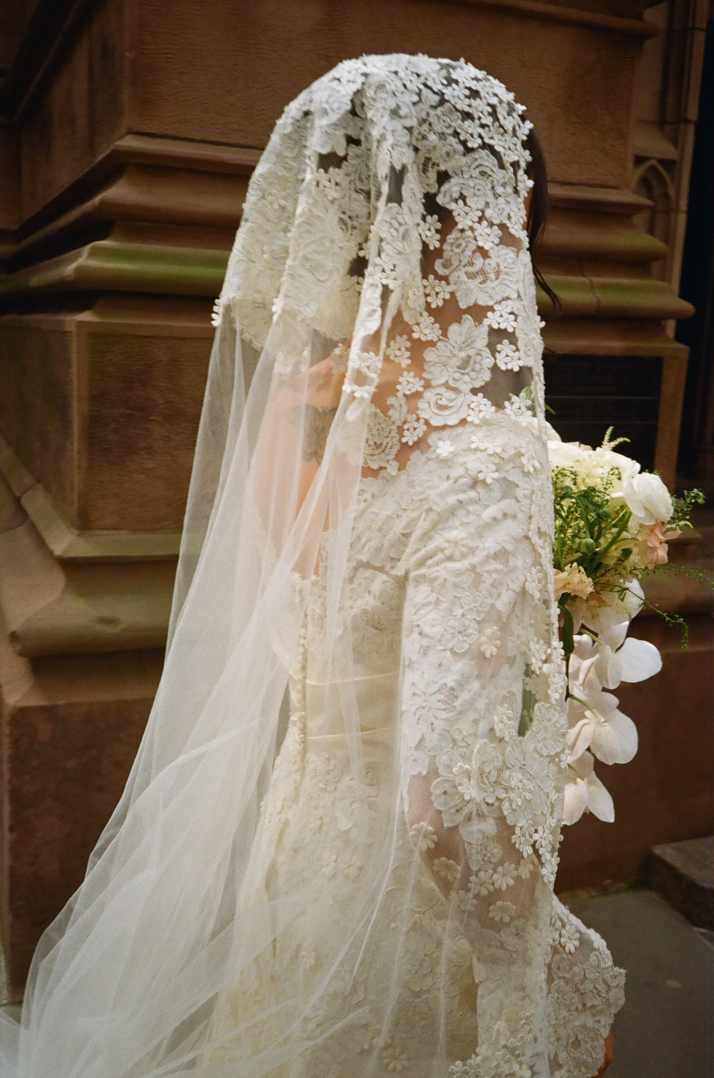 Back view of bride wearing lace vintage veil from Maybelle NYC.