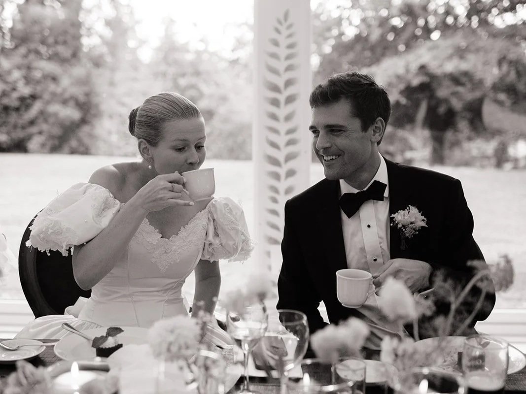 Wedding couple drinking coffee, while she wears a vintage bride dress from Maybelle NYC.