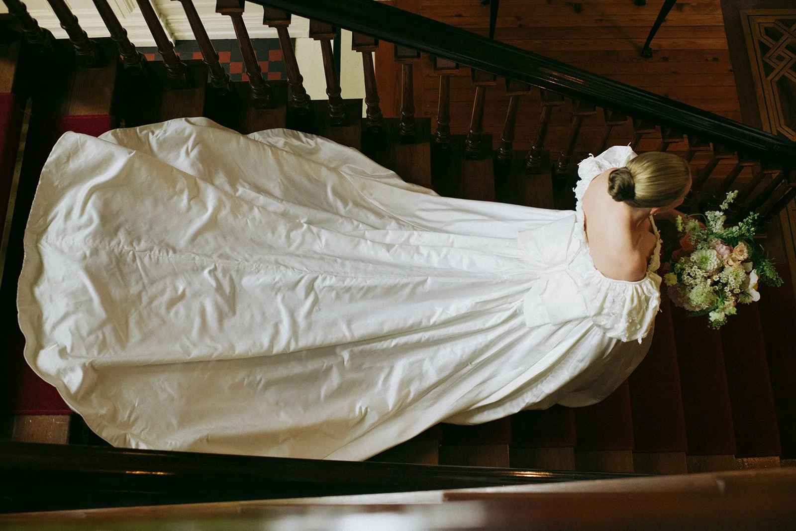 Bride walking down the stairs in vintage bridal dress from Maybelle.