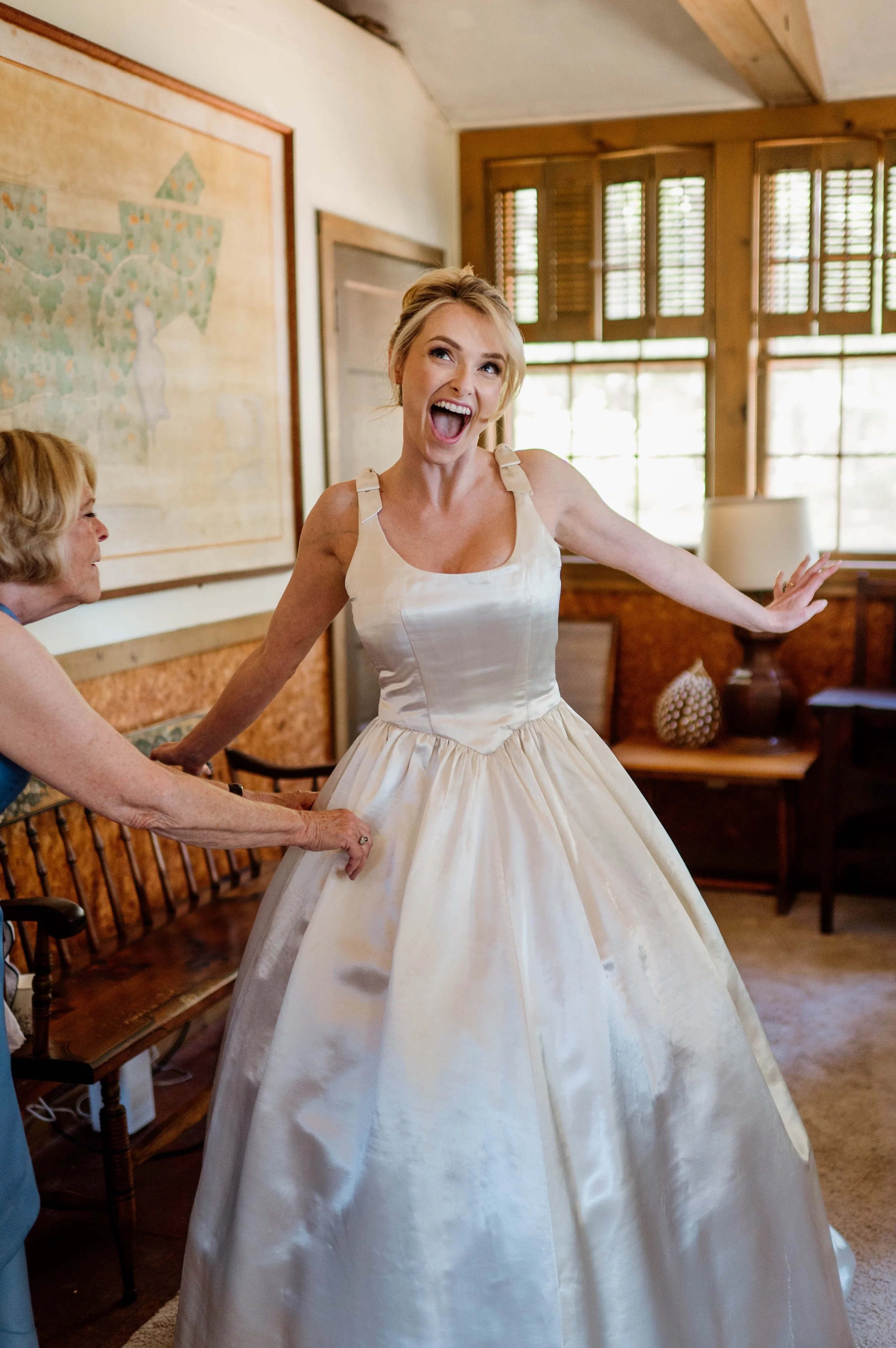 Joyful bride wearing her family heirloom wedding dress, redesigned by Maybelle.