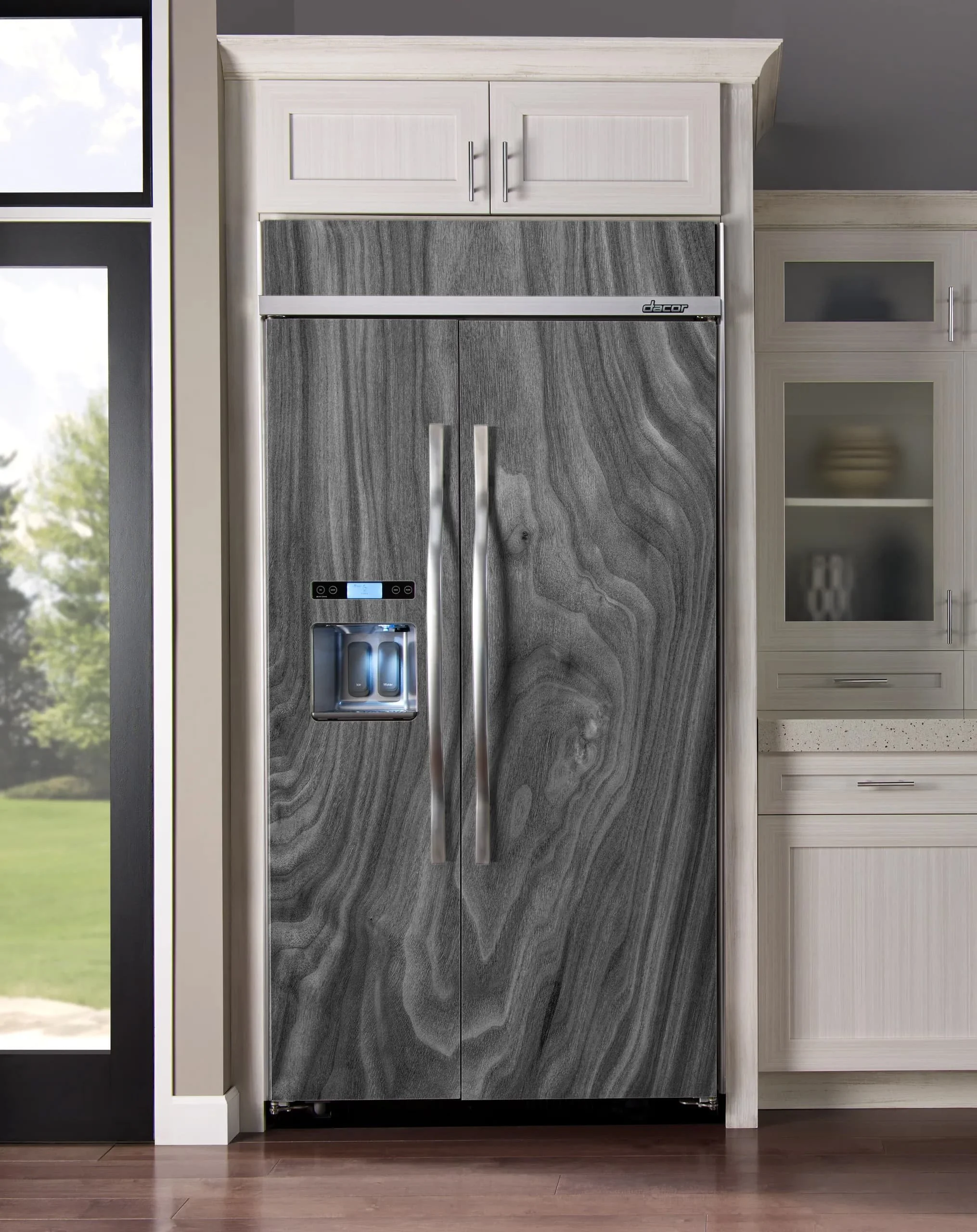 A side-by-side style refrigerator in a modern kitchen shown wrapped with a black & white walnut wood slab custom-printed vinyl skin.