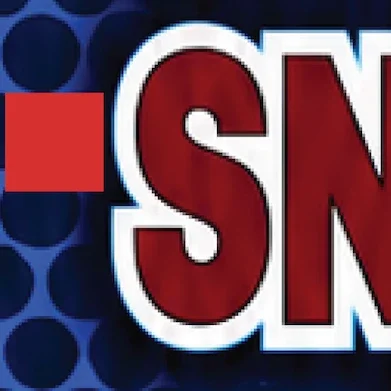 Close-up of bold red and white letters over a blue geometric background