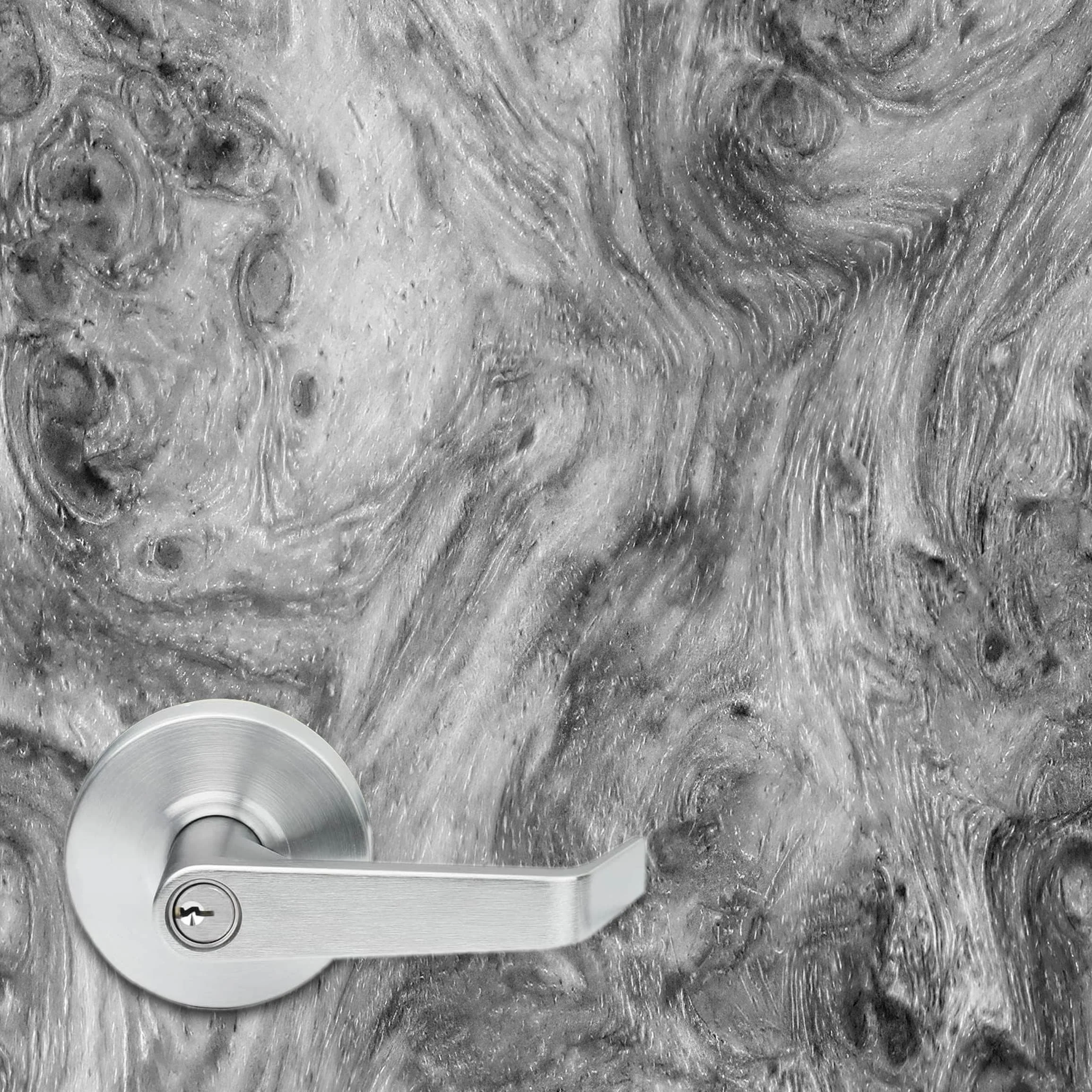 Close up of a high resolution amboyna burl wood texture vinyl door wrap. A typical 5.375" office door handle is shown to give a sense of scale and to show the detailing in the wood texture.
