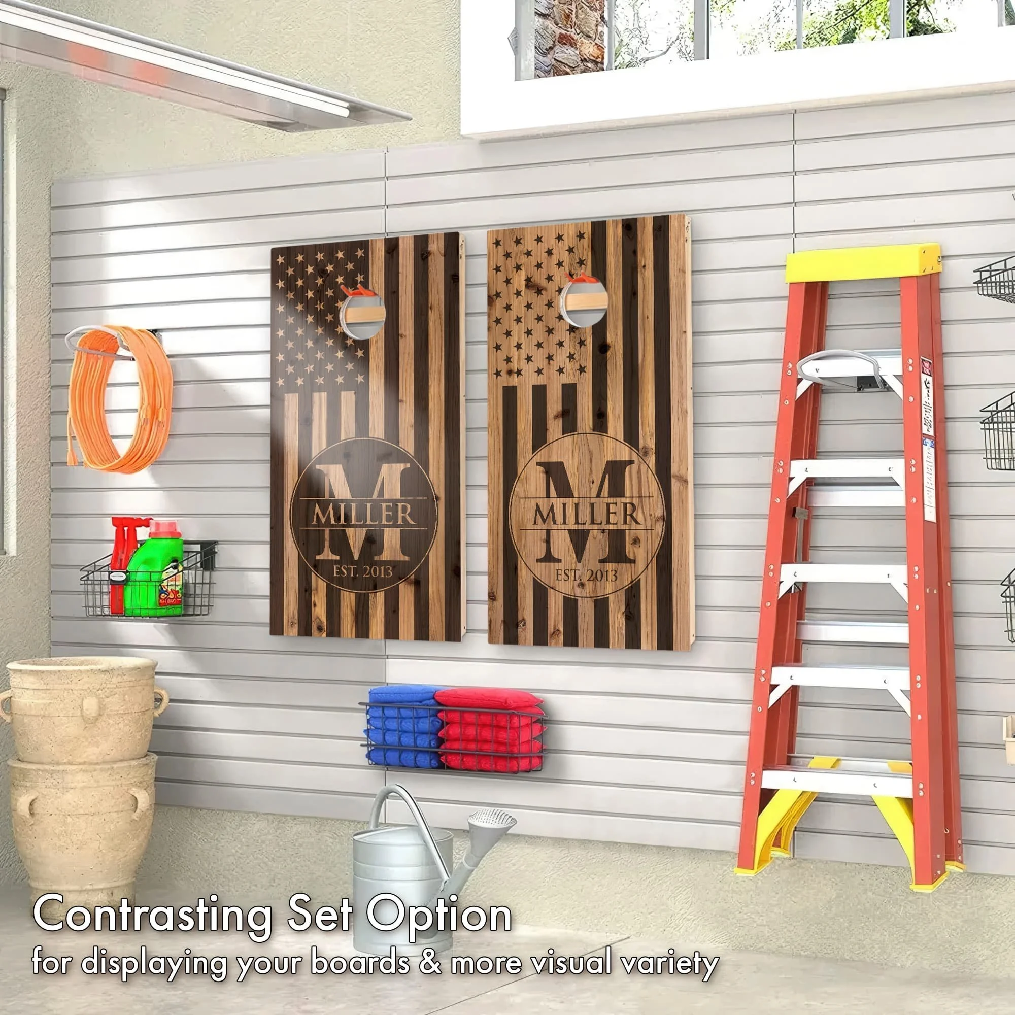Contrasting Monogram wood USA flag personalized custom Cornhole boards hanging on display in a garage