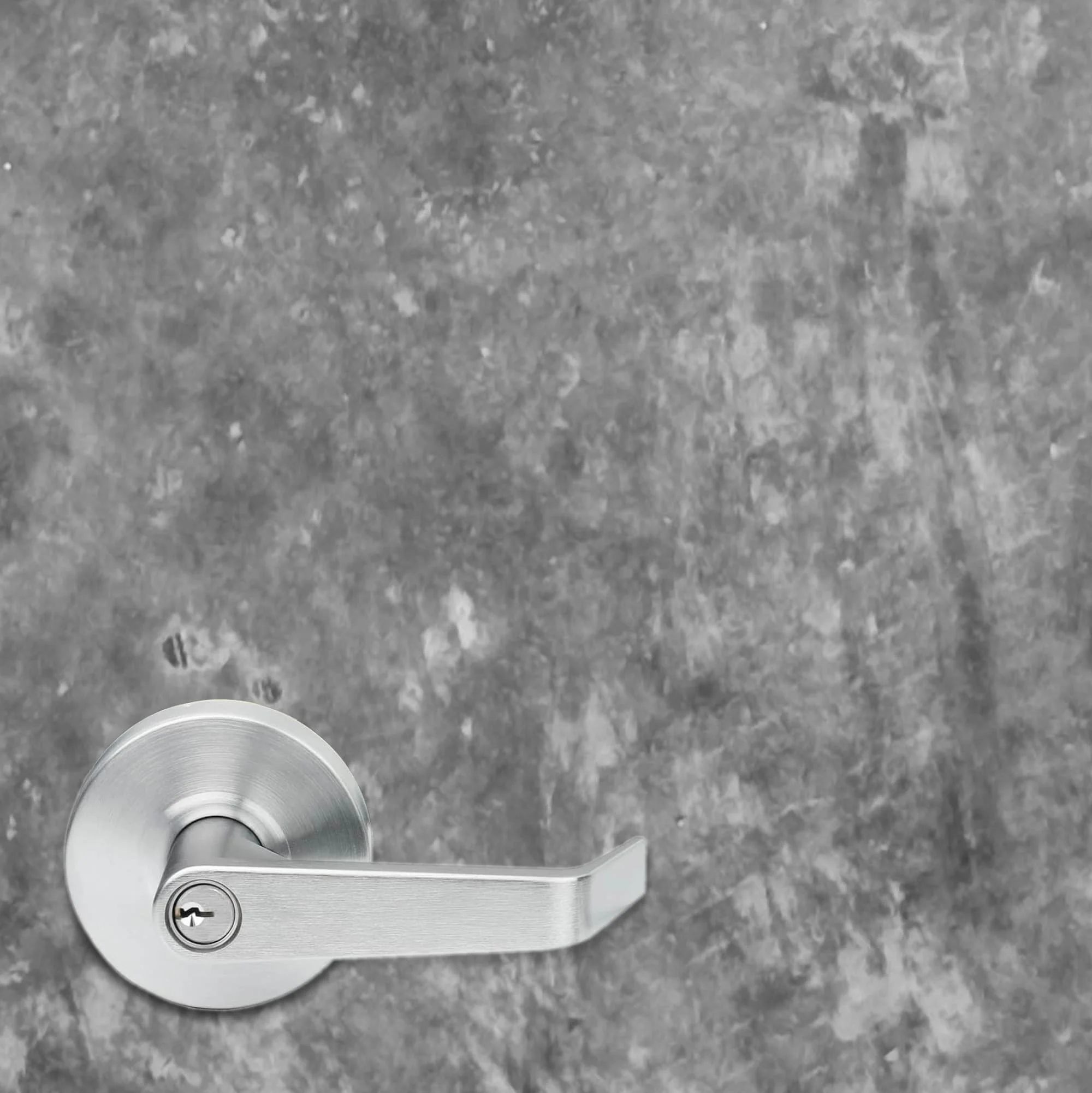Close up of a high resolution concrete texture vinyl door wrap. A typical 5.375" office door handle is shown to give a sense of scale and to show the detailing in the concrete texture.