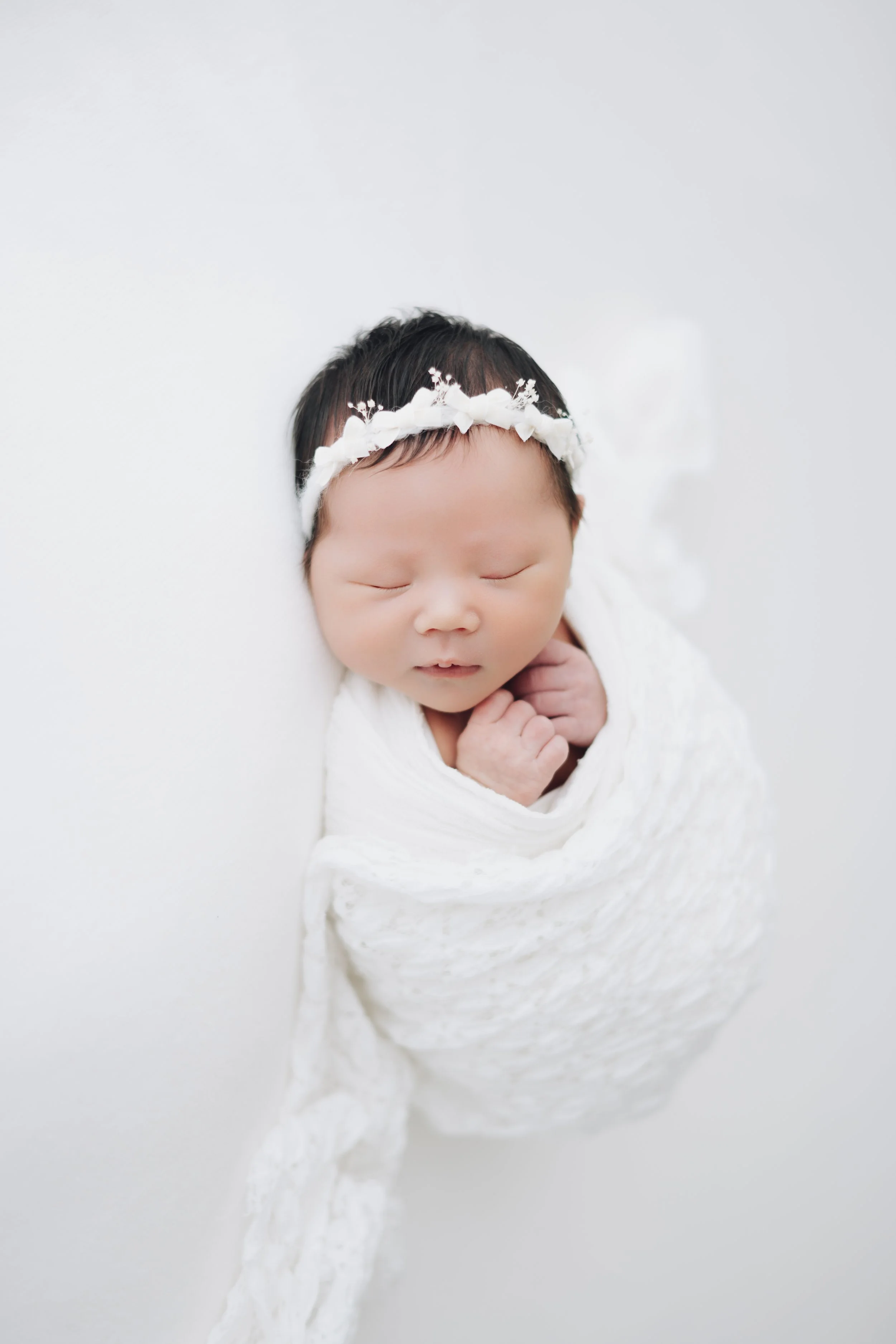 Newborn baby photographed in natural light studio in Houston by Grettart