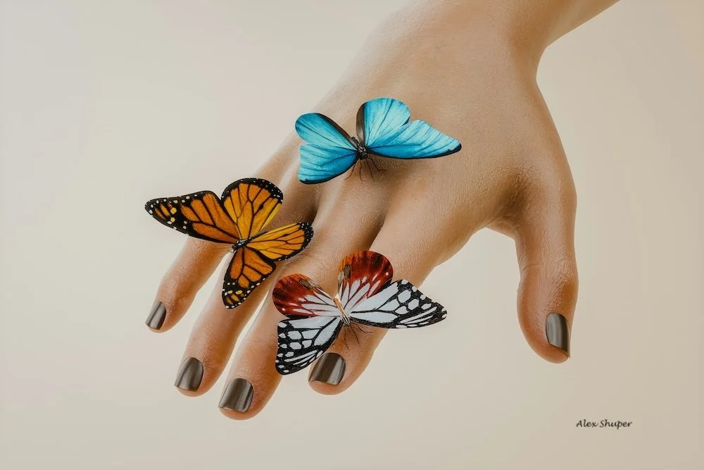 Butterflies resting on a hand - mindful summer moment help us with savouring life.