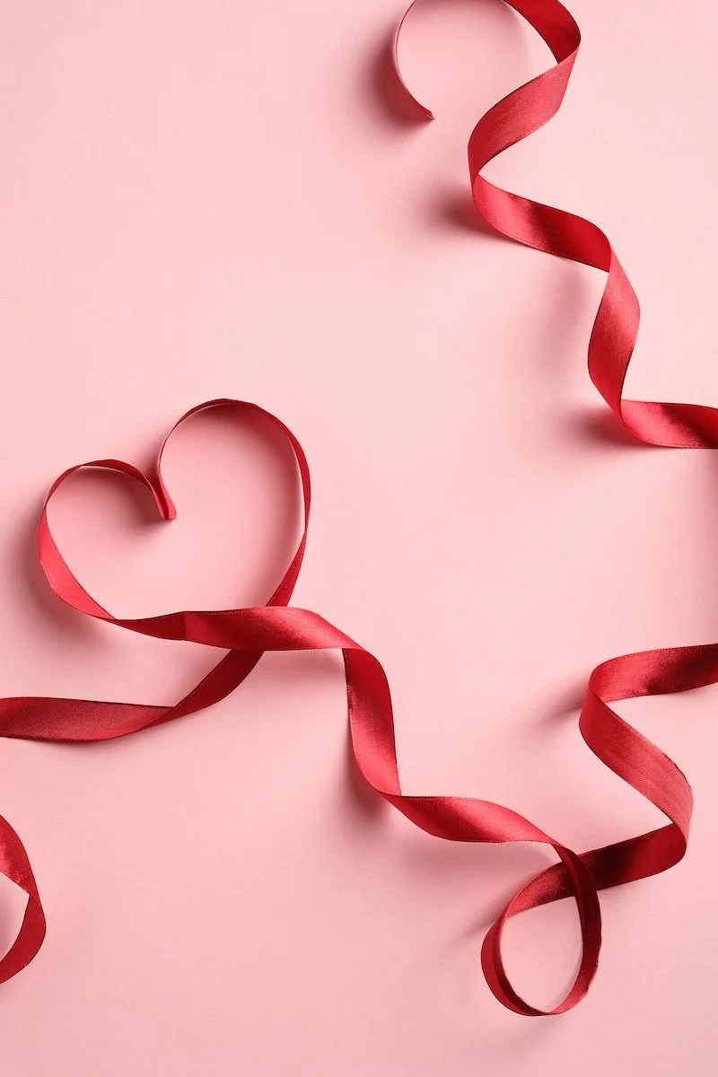 A heart created out of a red ribbon.