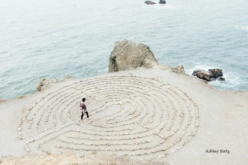 A person walking in a meditation circle.