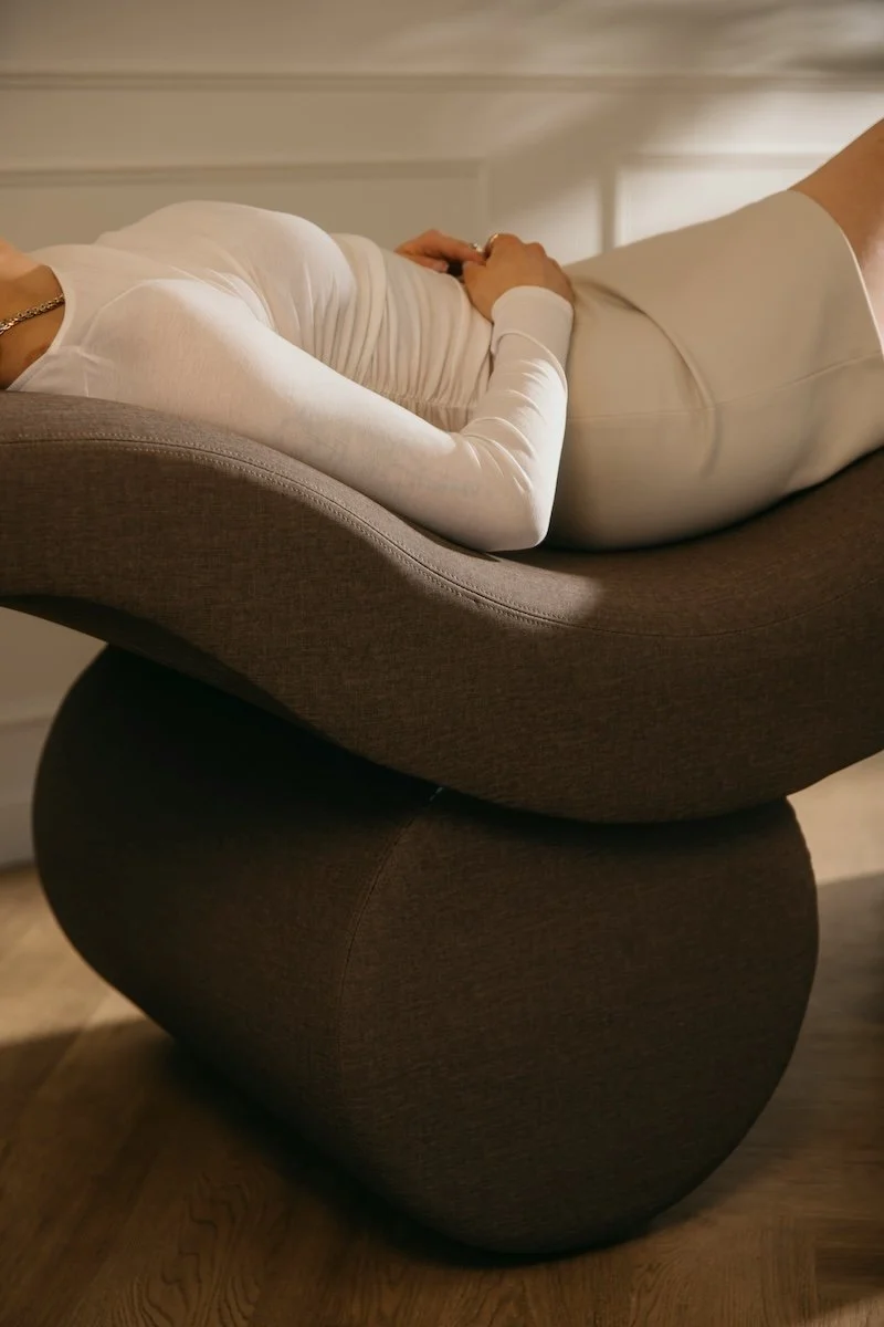 A woman laying back and meditating.