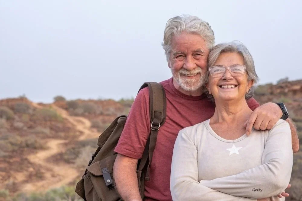 A senior couple is out hiking and discovering new passions.