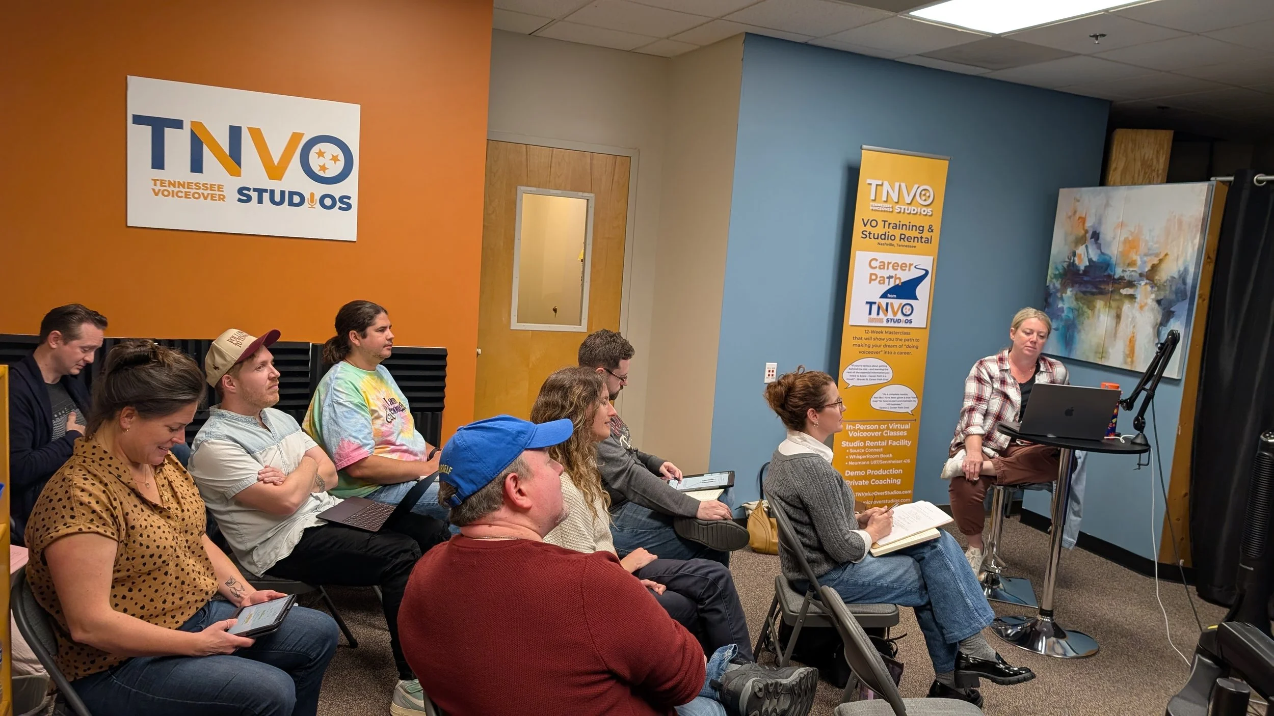 Group Voiceover class with everyone looking at instructor