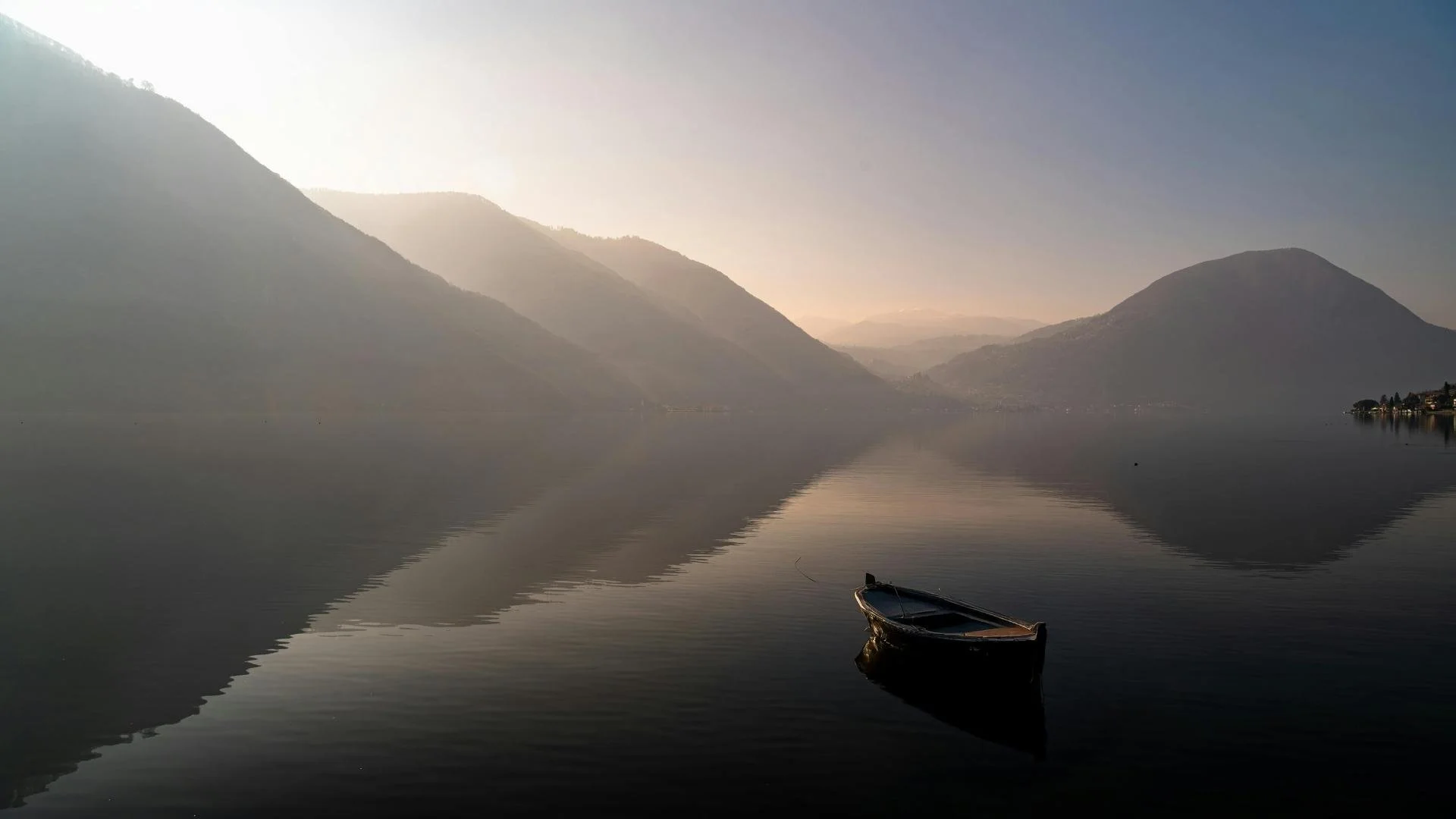 boat on lake with mountains