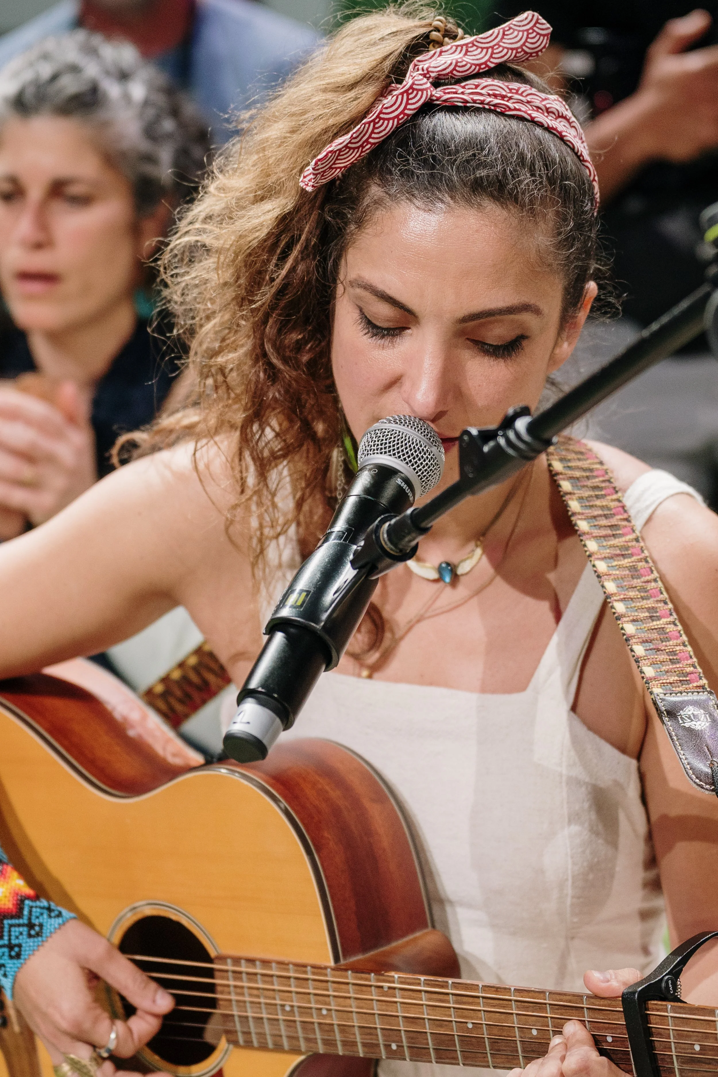 Live event photography capturing a music performance on stage with audience engagement.