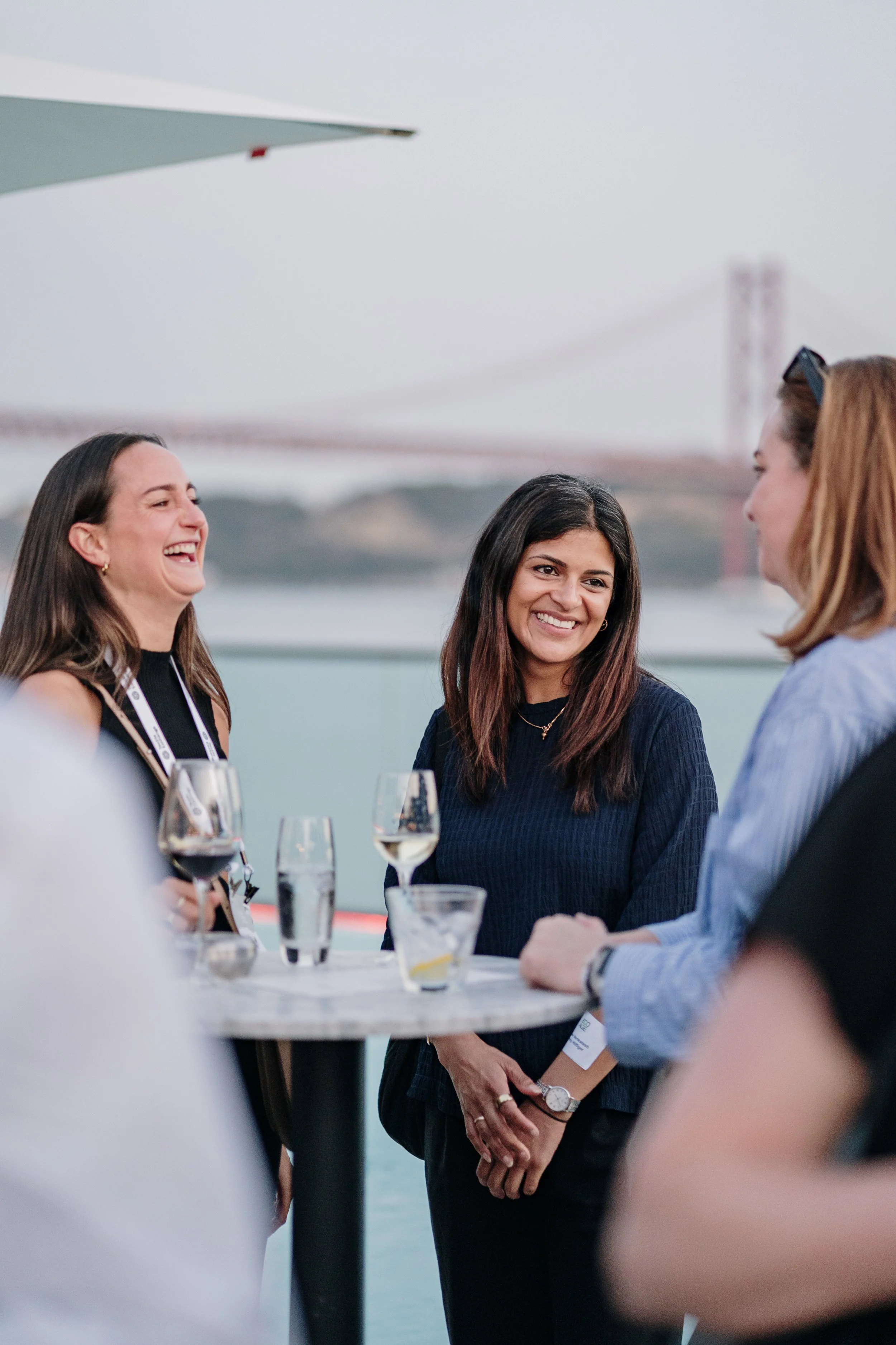 Event photography capturing natural networking moments between attendees during a professional event.