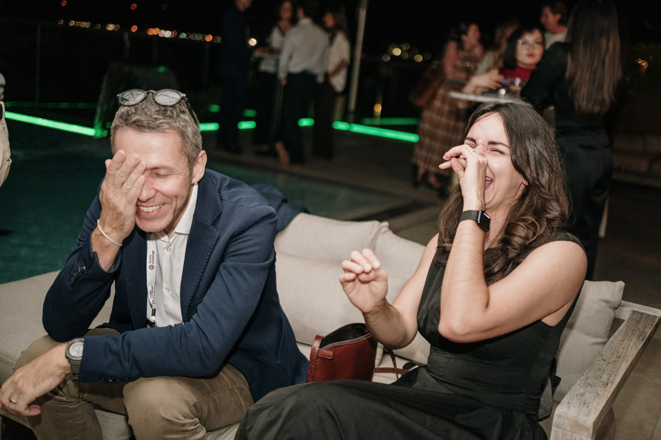 Event photography capturing natural networking moments between attendees during a professional event.