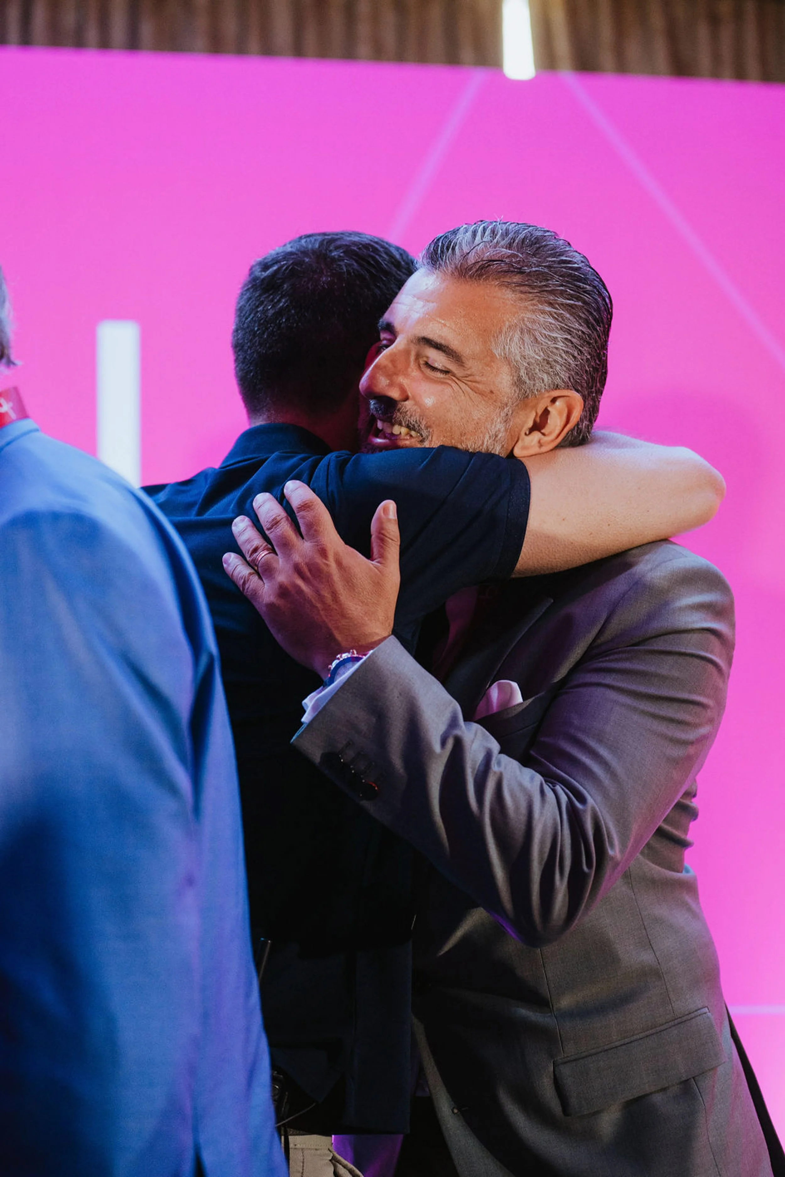 People hugging on stage