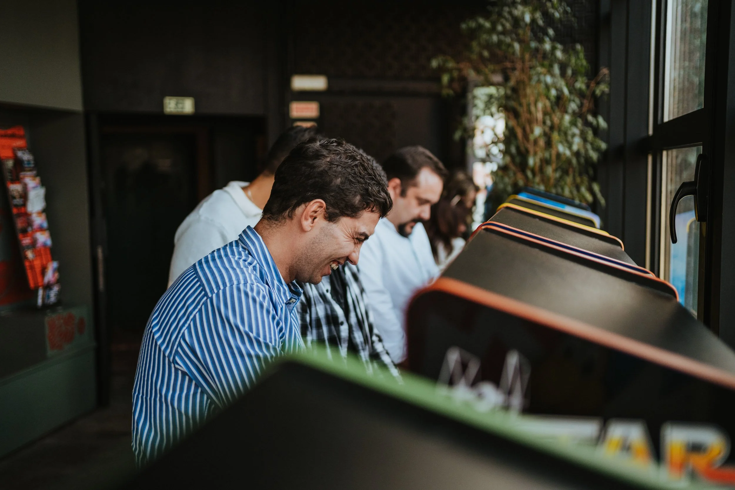People playing arcade games at an event